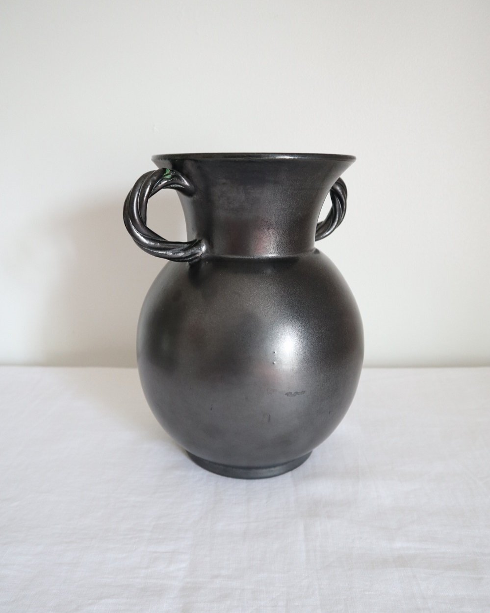 Large glossy, metallic black vase with double twisted handles and contrasting, yellow crackled glaze interior. Typical of Elchinger productions, France. Circa 1950s