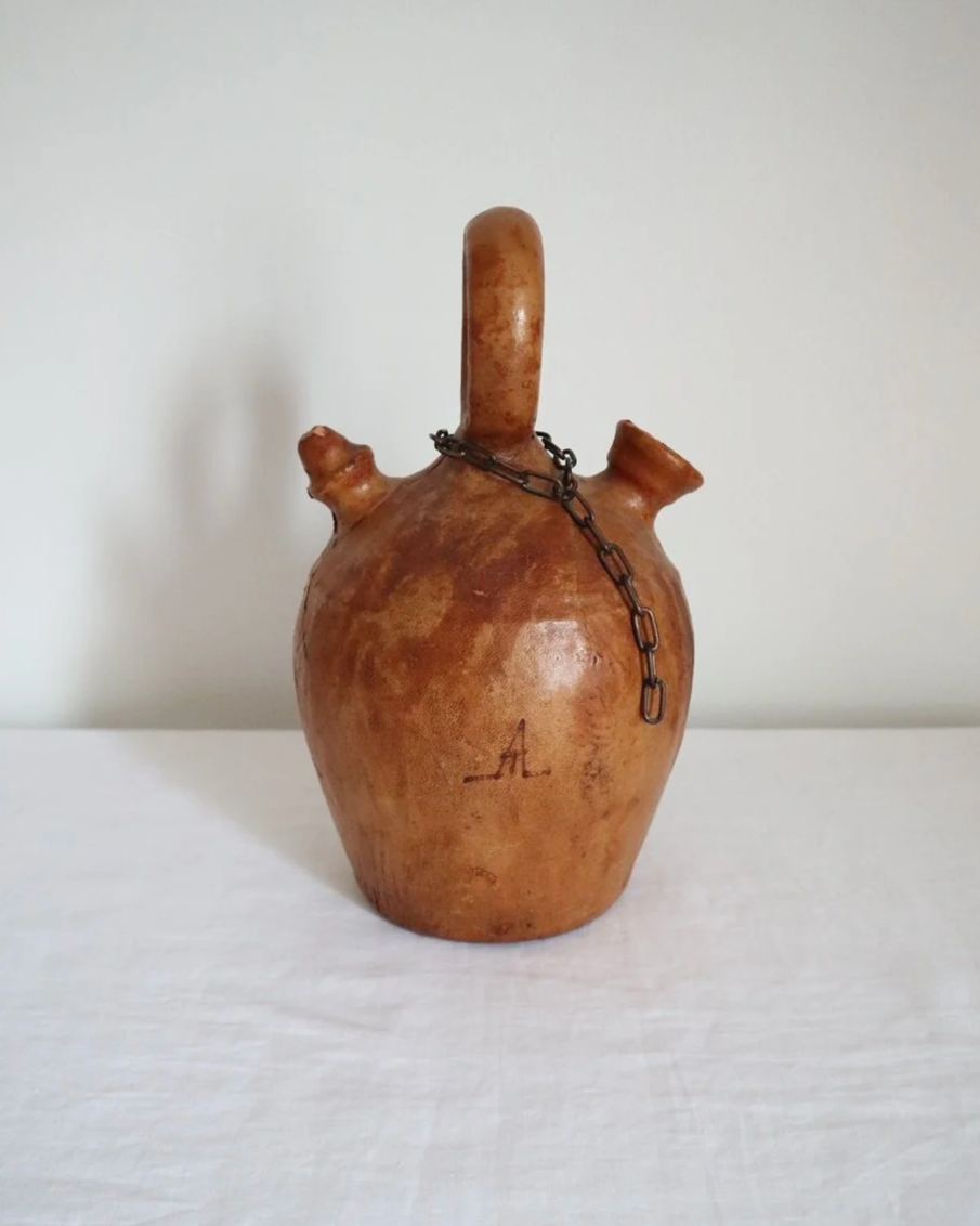 Spanish distressed tan leather covered oil or water pourer.