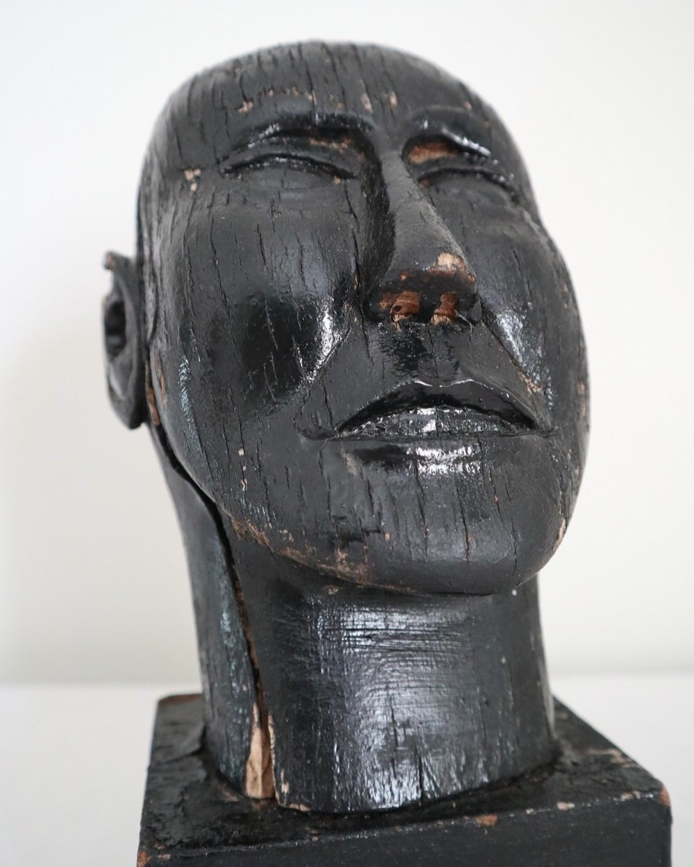 Vintage hand carved black painted wooden sculpture of male head. Age unknown.