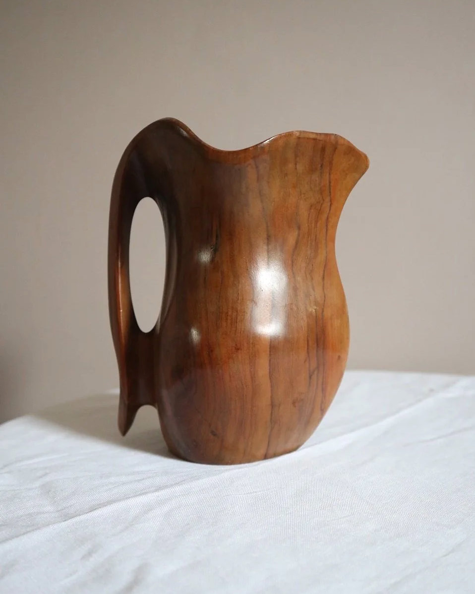Small mid century hand carved sculptural olivewood jug in the style of Alexandre Noll. Circa 1960s.