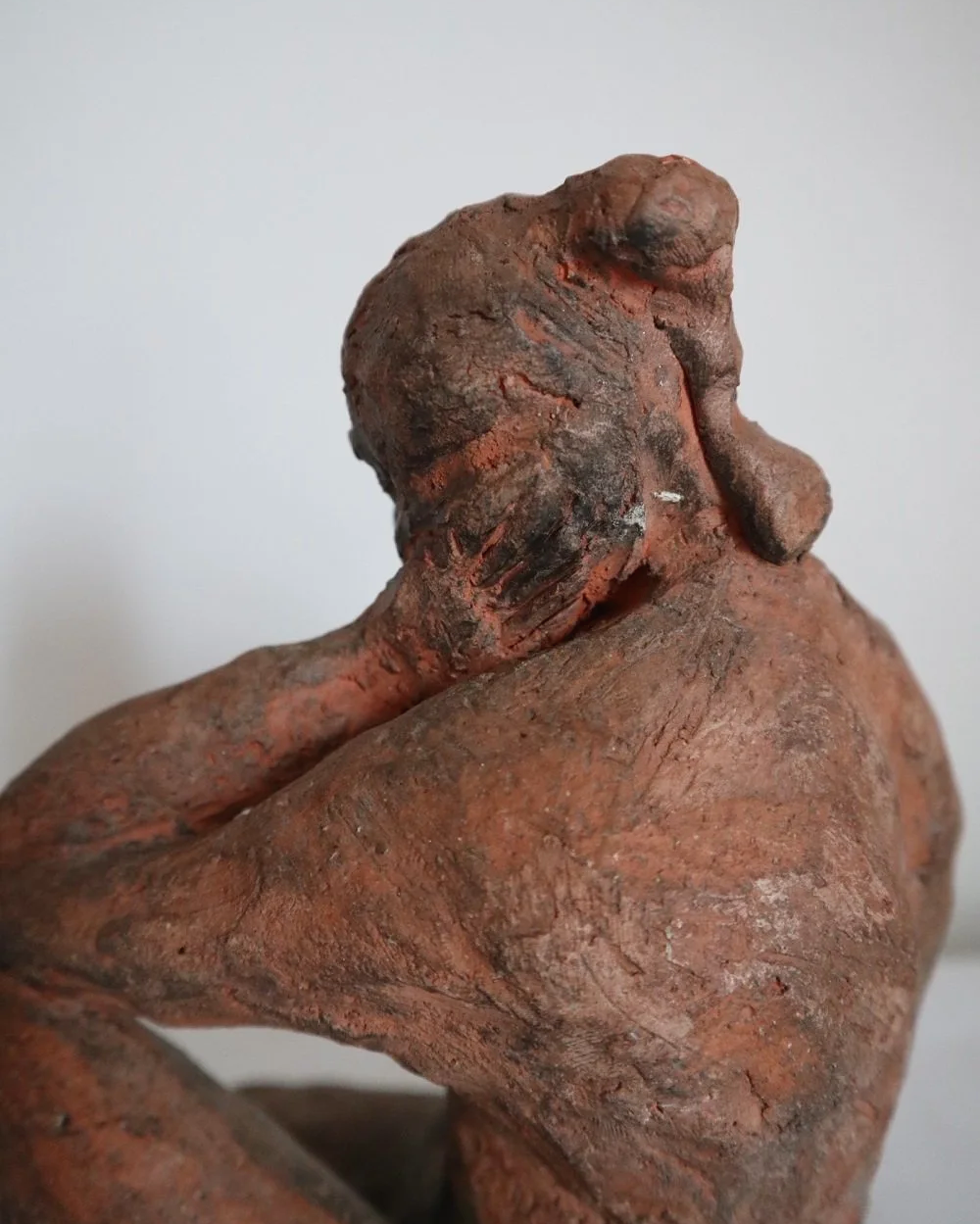 Heavy handmade studio pottery textured sculpture of seated nude woman.