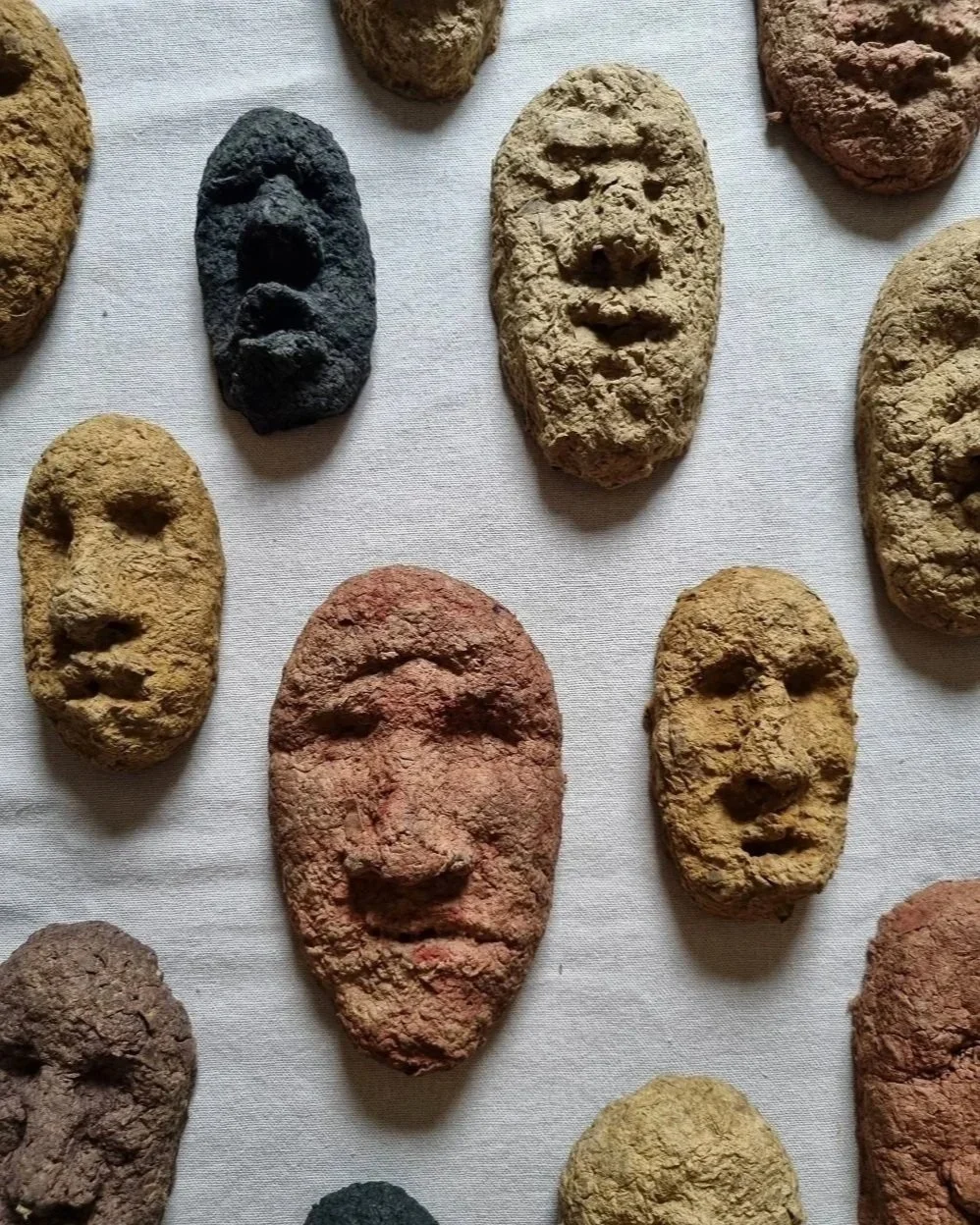 Set of unique handmade textured papier mache faces in earthy tones. Unknown age.  Unknown artist.
