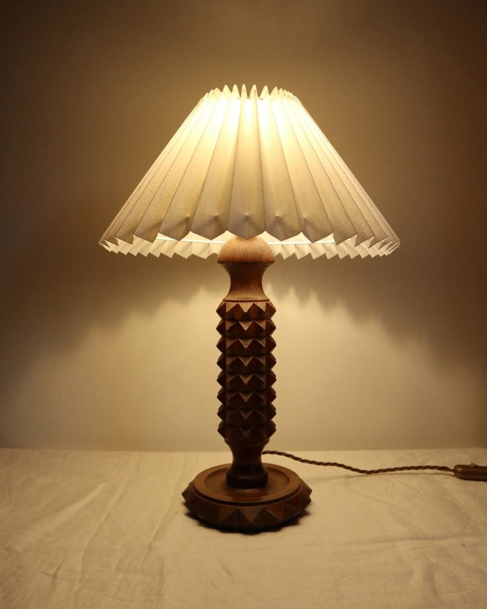 French Charles Dudouyt style carved wooden Brutalist table lamp with new, white pleated lampshade.