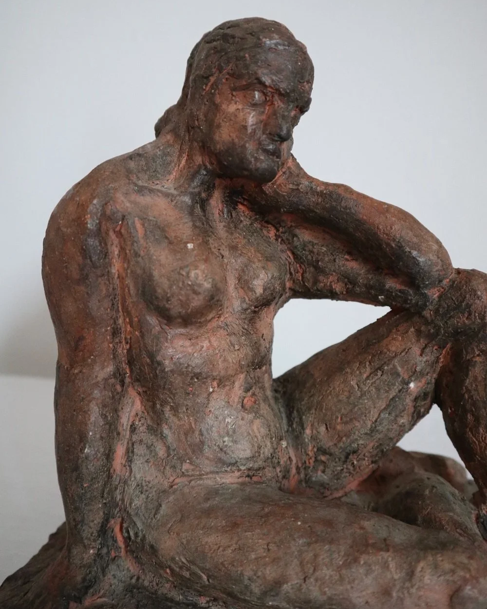 Heavy handmade studio pottery textured sculpture of seated nude woman.
