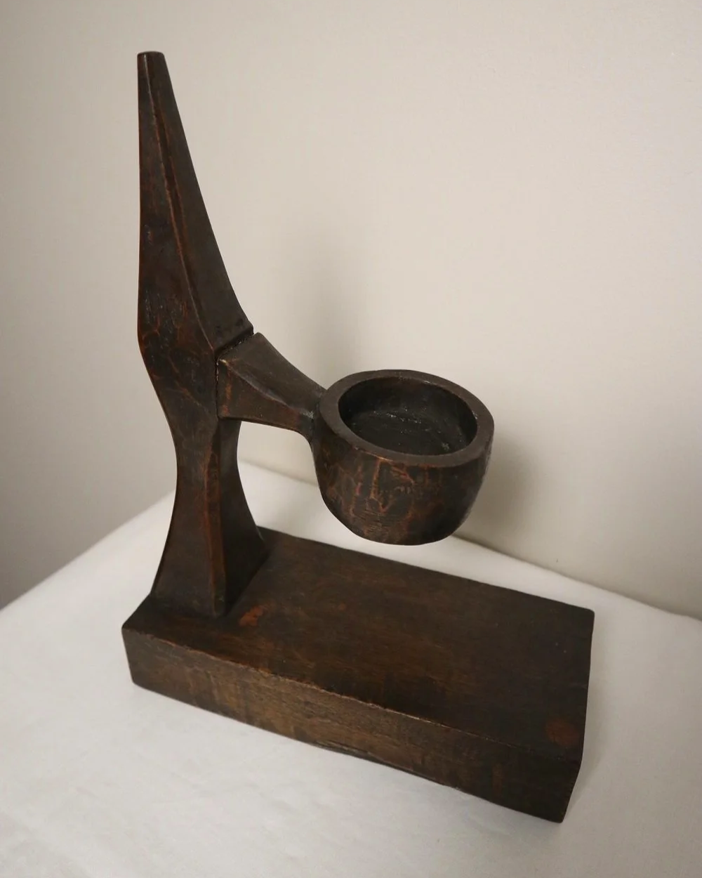American hand carved dark wooden Brutalist candleholder with block base.