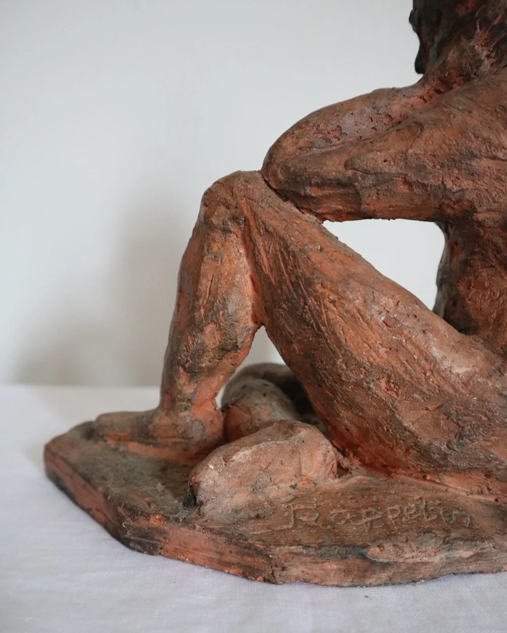 Heavy handmade studio pottery textured sculpture of seated nude woman.