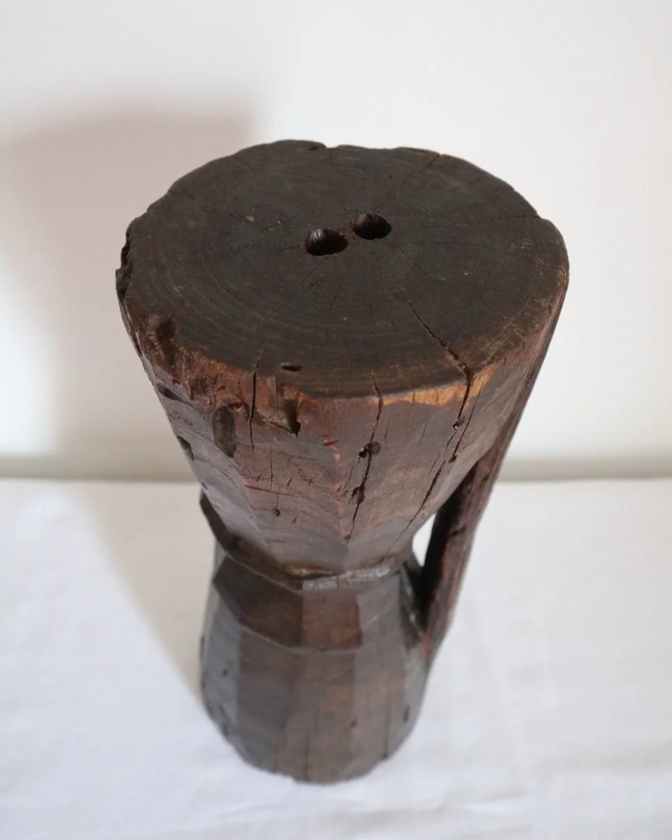 Heavy primitive sculptural carved wooden mortar with handle.