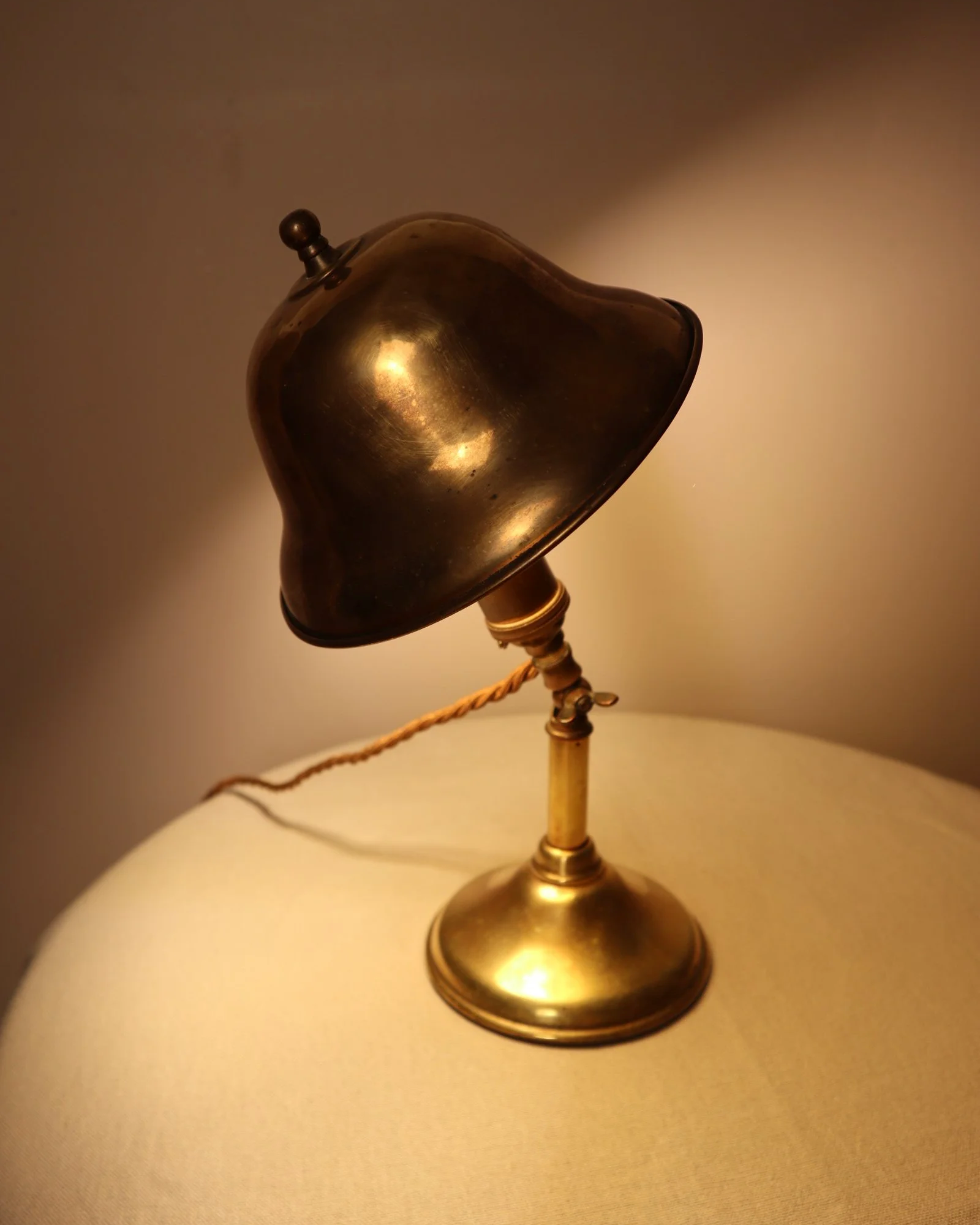 Small, vintage adjustable brass worker's desk lamp. Can be freestanding or attached to the edge of a workbench etc with clamp.