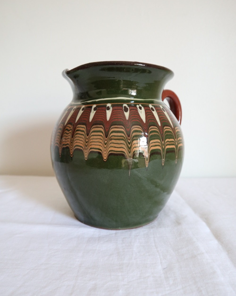 Large Bulgarian green and brown ceramic pitcher jug in traditional Troyan style.