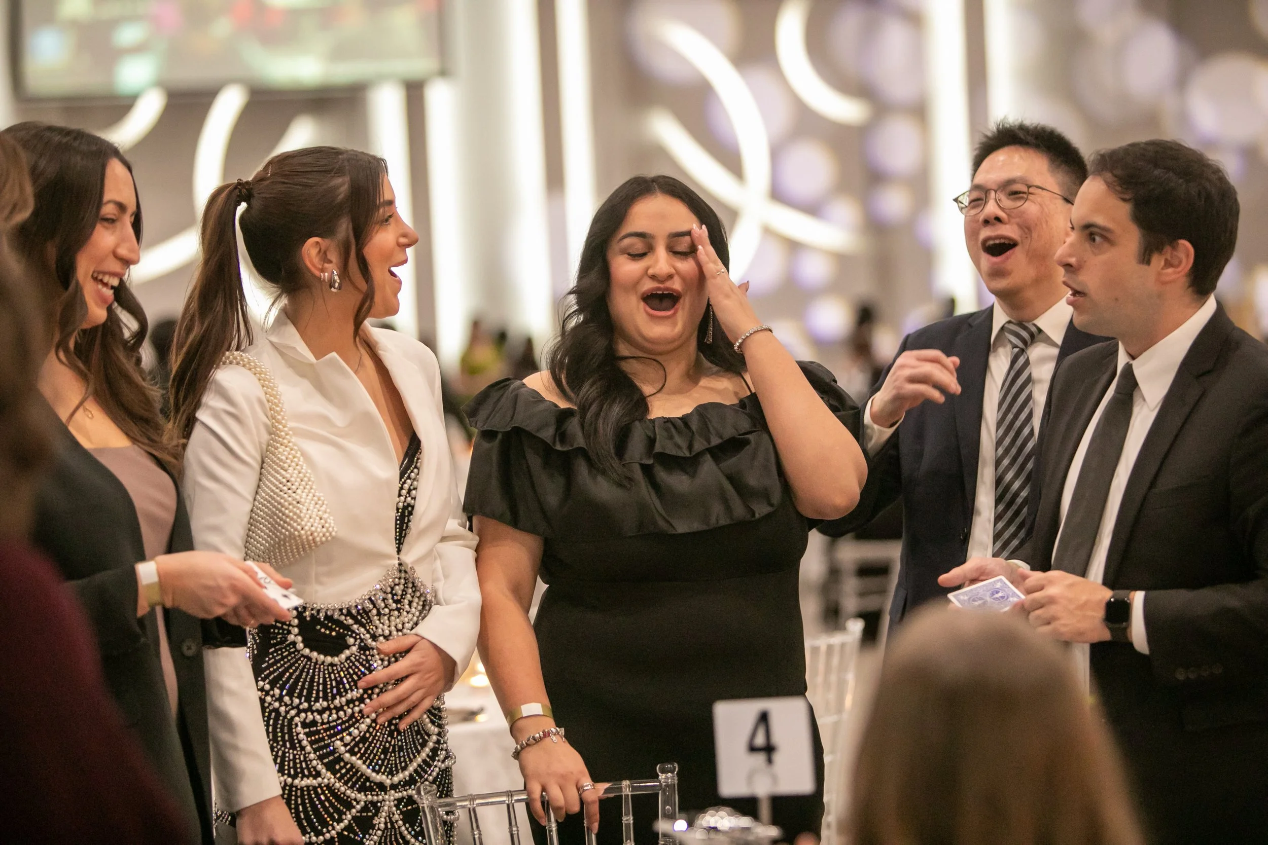Close-up magician entertaining guests during a Toronto corporate cocktail hour