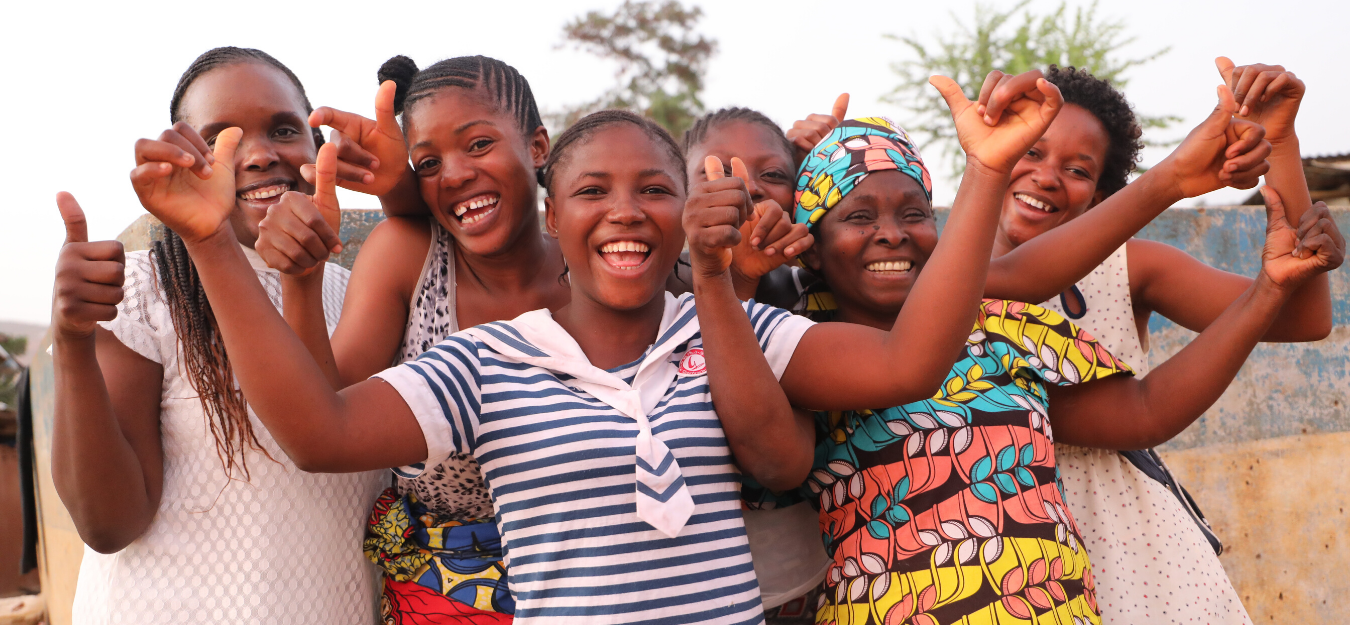 Group of young girls doing a thumbs up and representing the charity Equality Now.