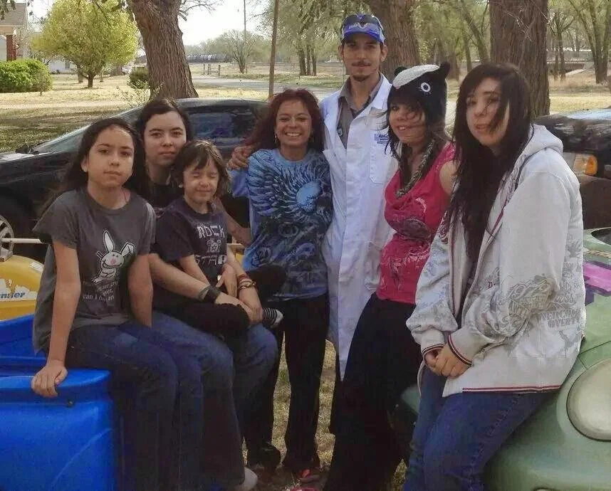 My mother, siblings, and myself in the white jacket. Dad is holding the camera.