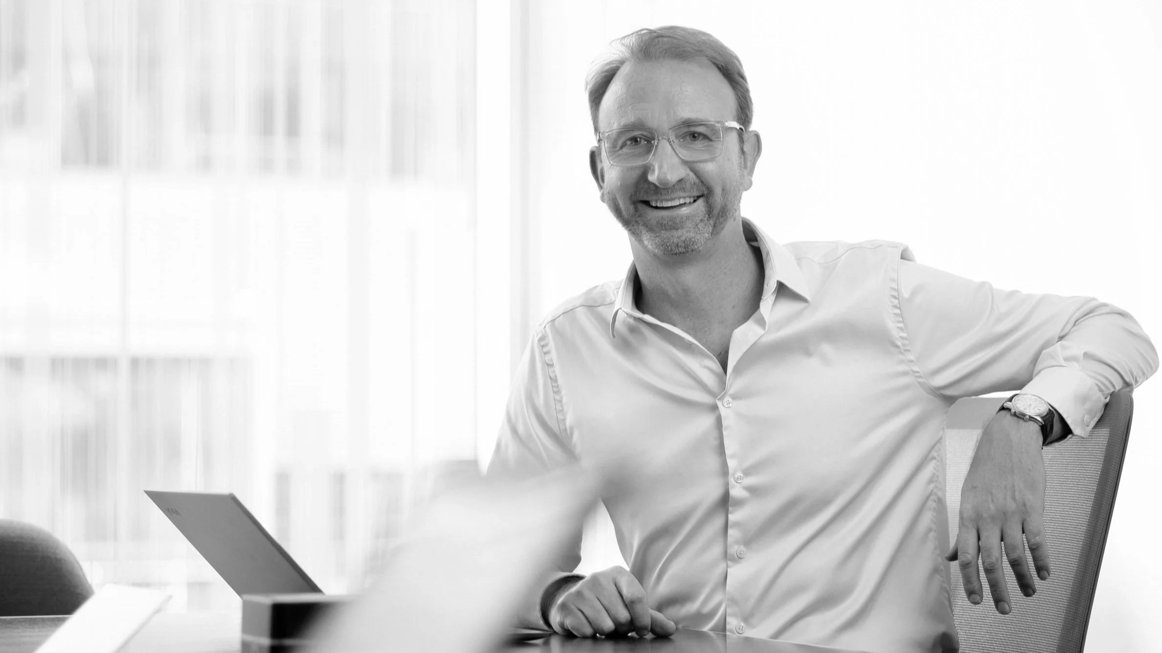 Mark Jeanes, Principal of Wiseworth, smiling at his desk