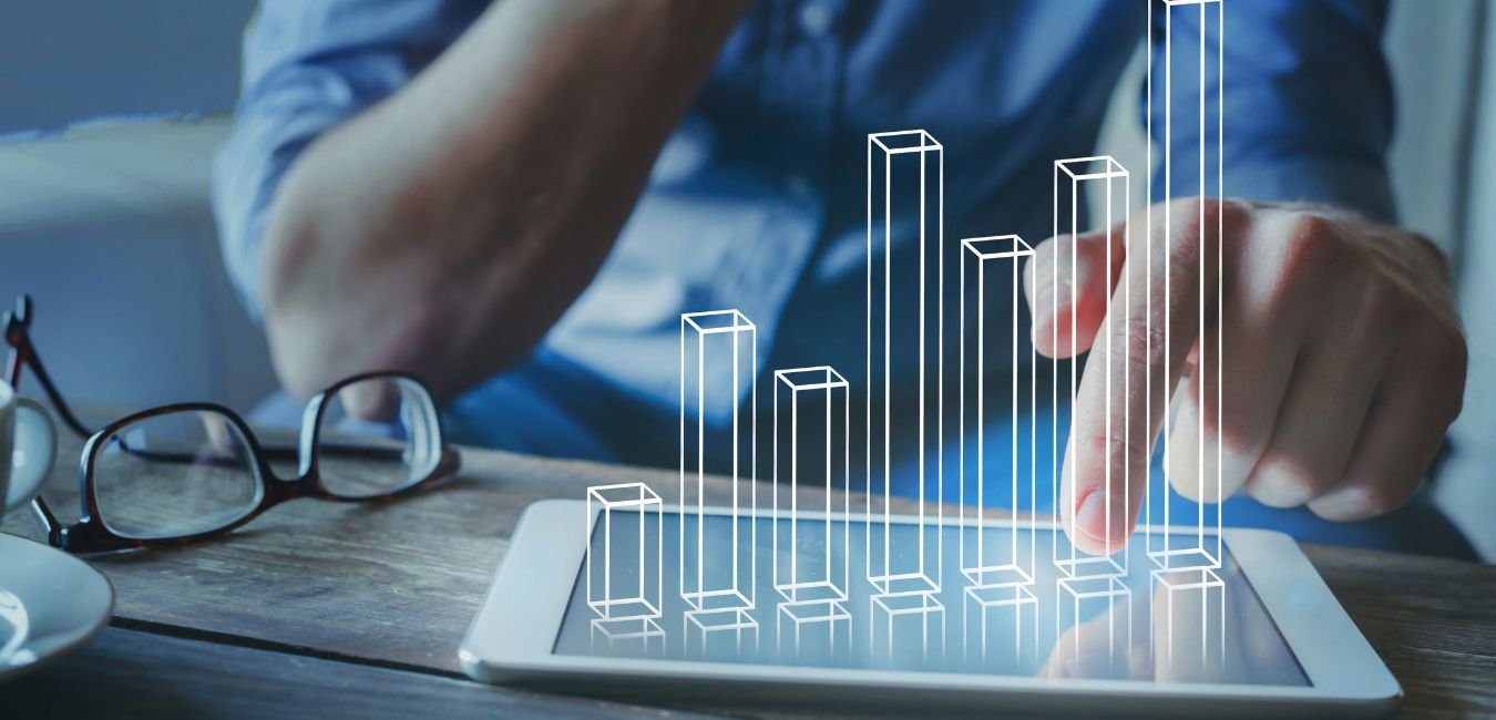 Melbourne financial modelling consultant analysing a rising bar chart projection on a tablet device