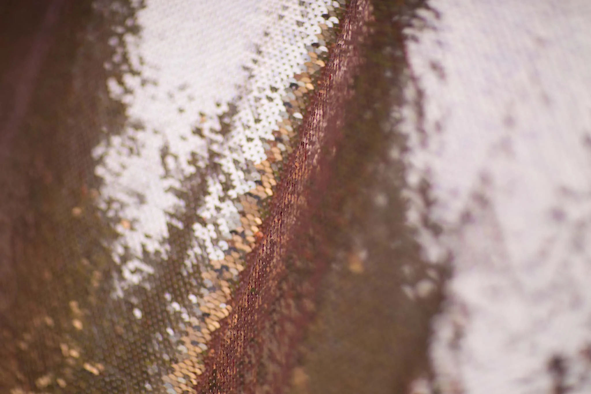 Close up photo of an Open Booths photo booth sparkly rose gold sequin backdrop