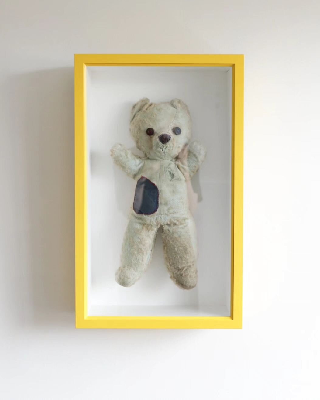 Another incredibly special job from last year was this much loved and treasured teddy.

The client opted for a bright and happy yellow frame to go with the primary colour, blue &amp; red stitching. We had a custom acrylic support made to bear the wei