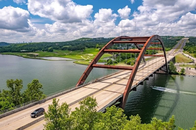 view of the colorado river and the penny backer 360 bridge in austin texas