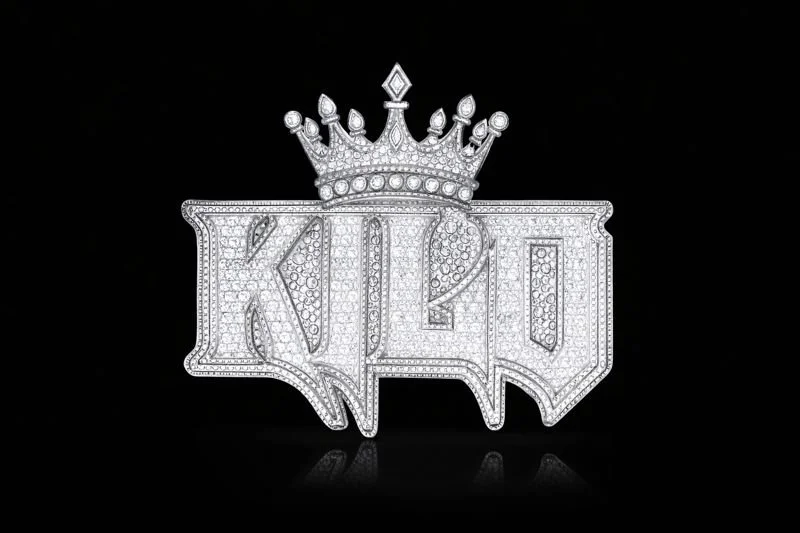 A diamond-encrusted badge with the word 'KING' and a crown on top, set against a black background.
