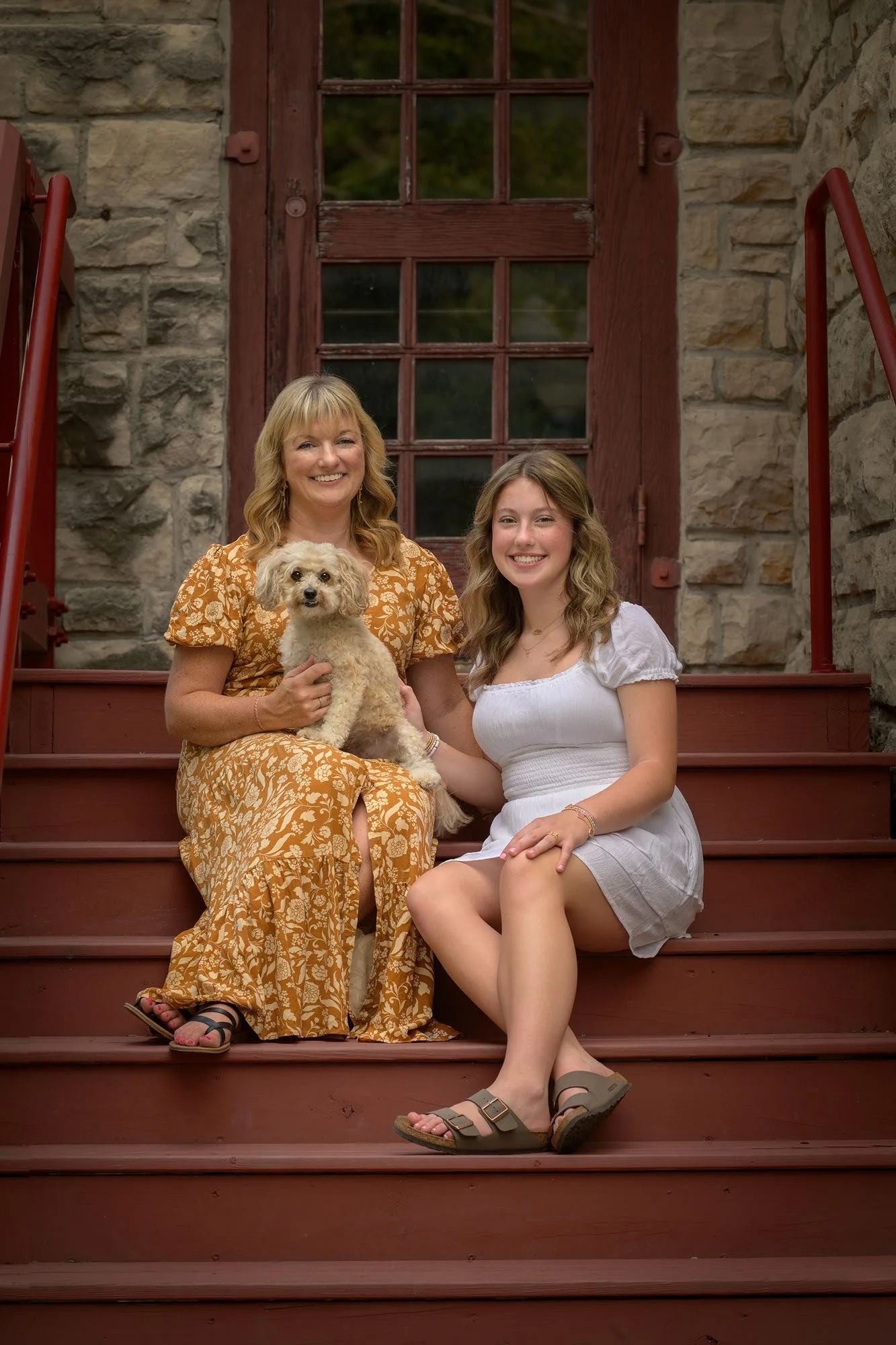 Pet and Family Photographer Iowa Illinois Mom and daughter sitting on stairwell with dog