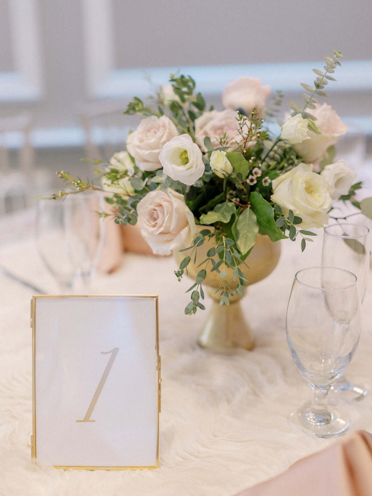 pink and white wedding centerpieces in gold vases