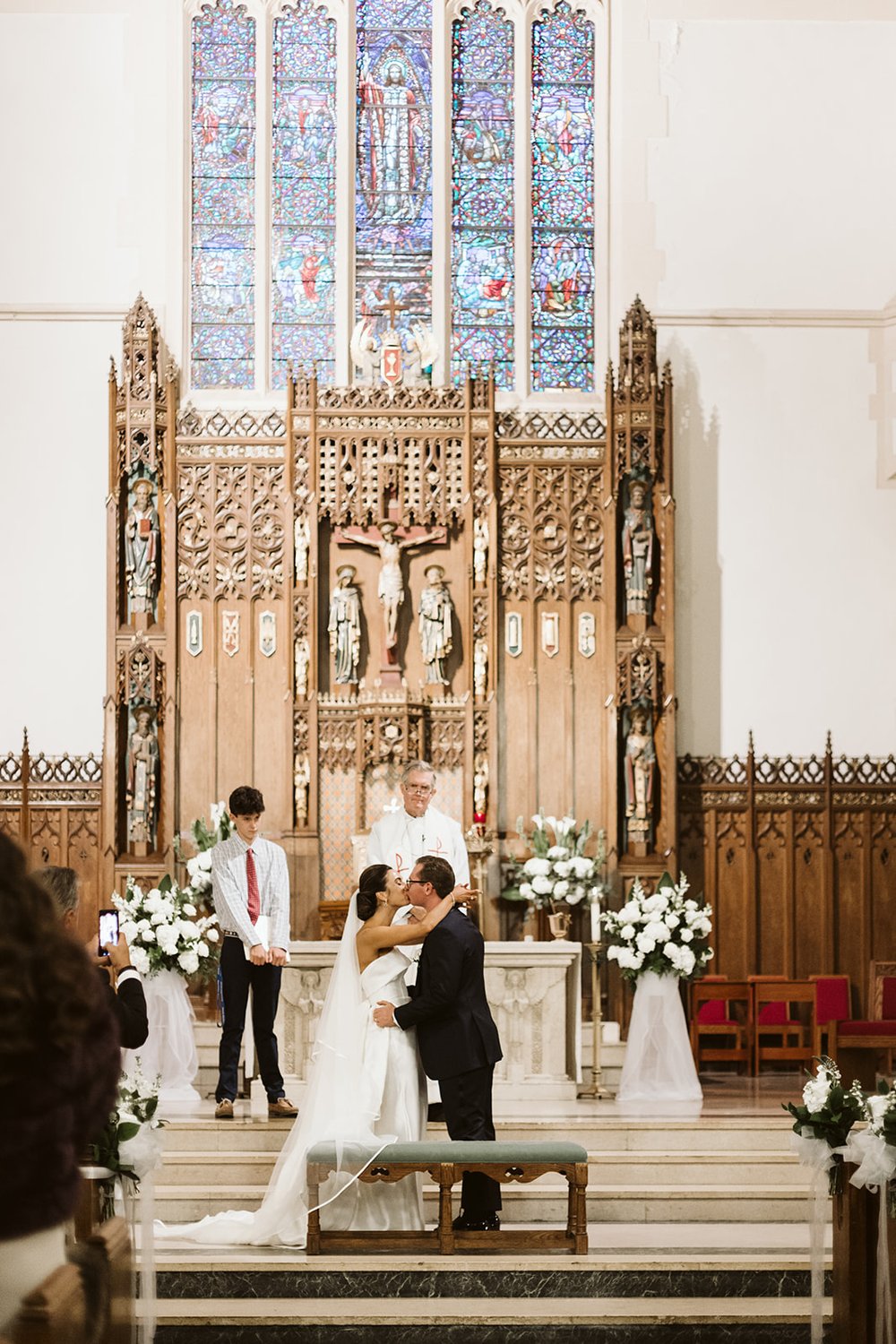 couple kiss during church wedding ceremony