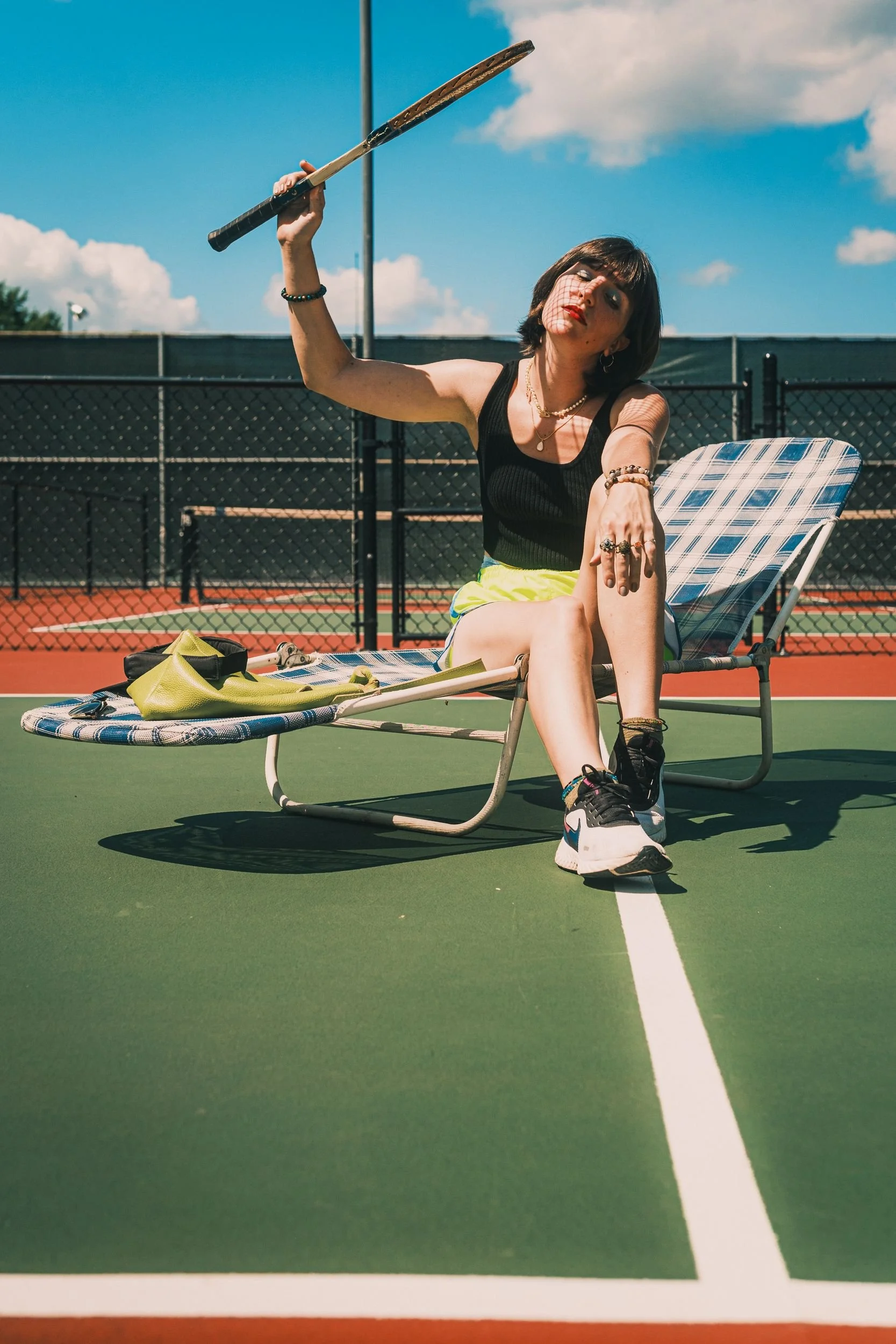 nicollete-tennis-editorial-raised-racket-seated.jpg
