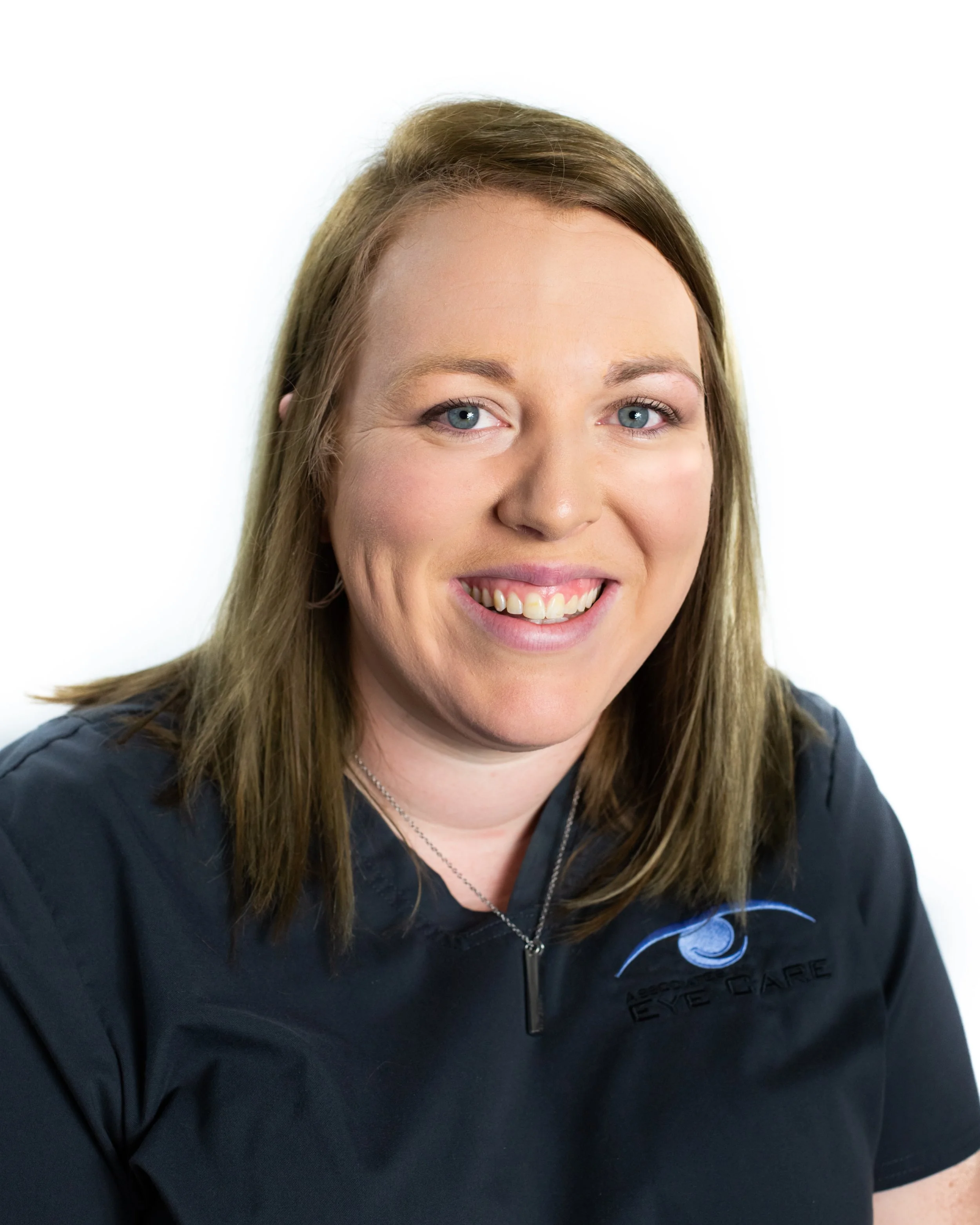 Person smiling, wearing a dark shirt with an optometry-related logo.