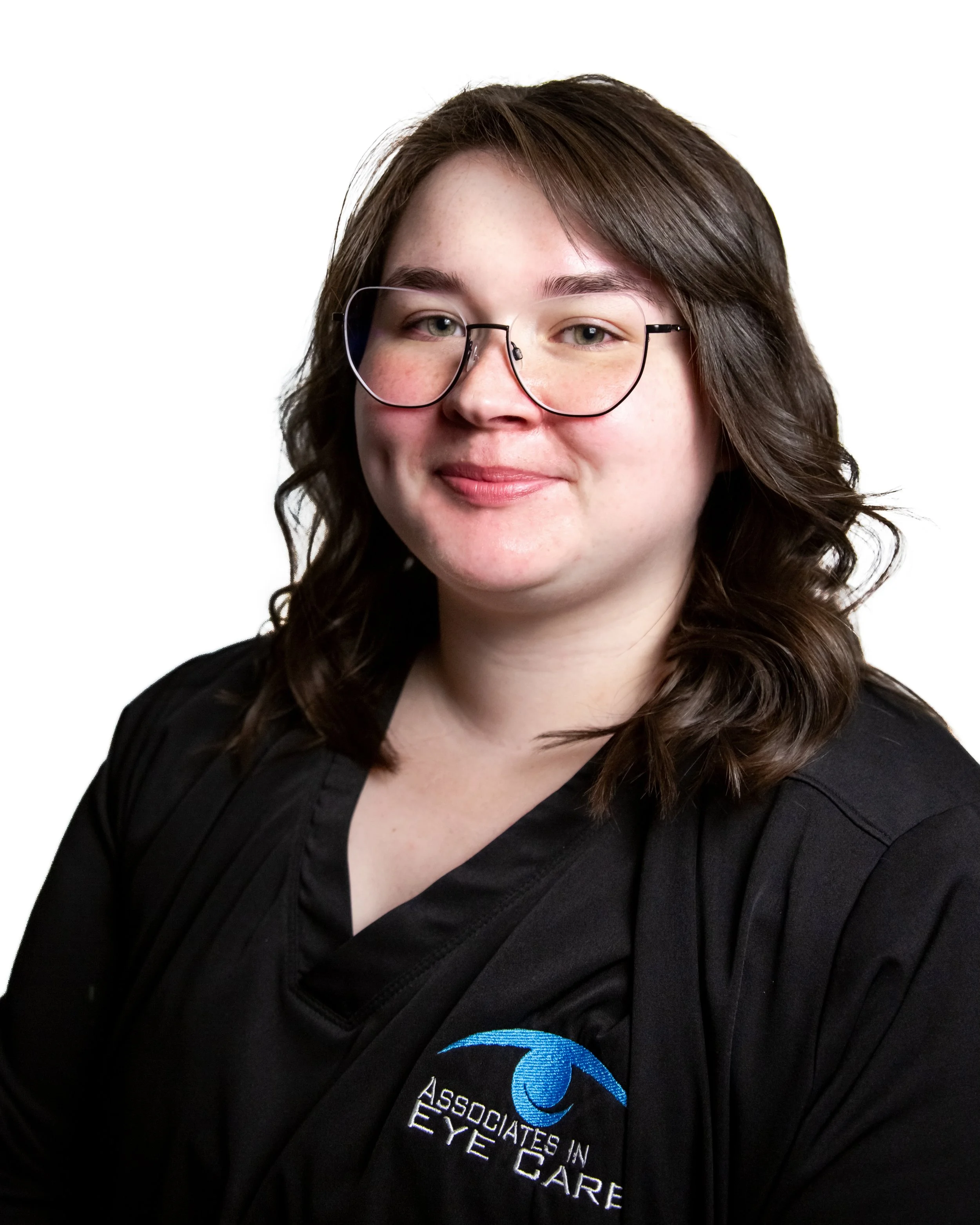 Person wearing glasses and a black shirt with 'Associates in Eye Care' logo, smiling against white background.