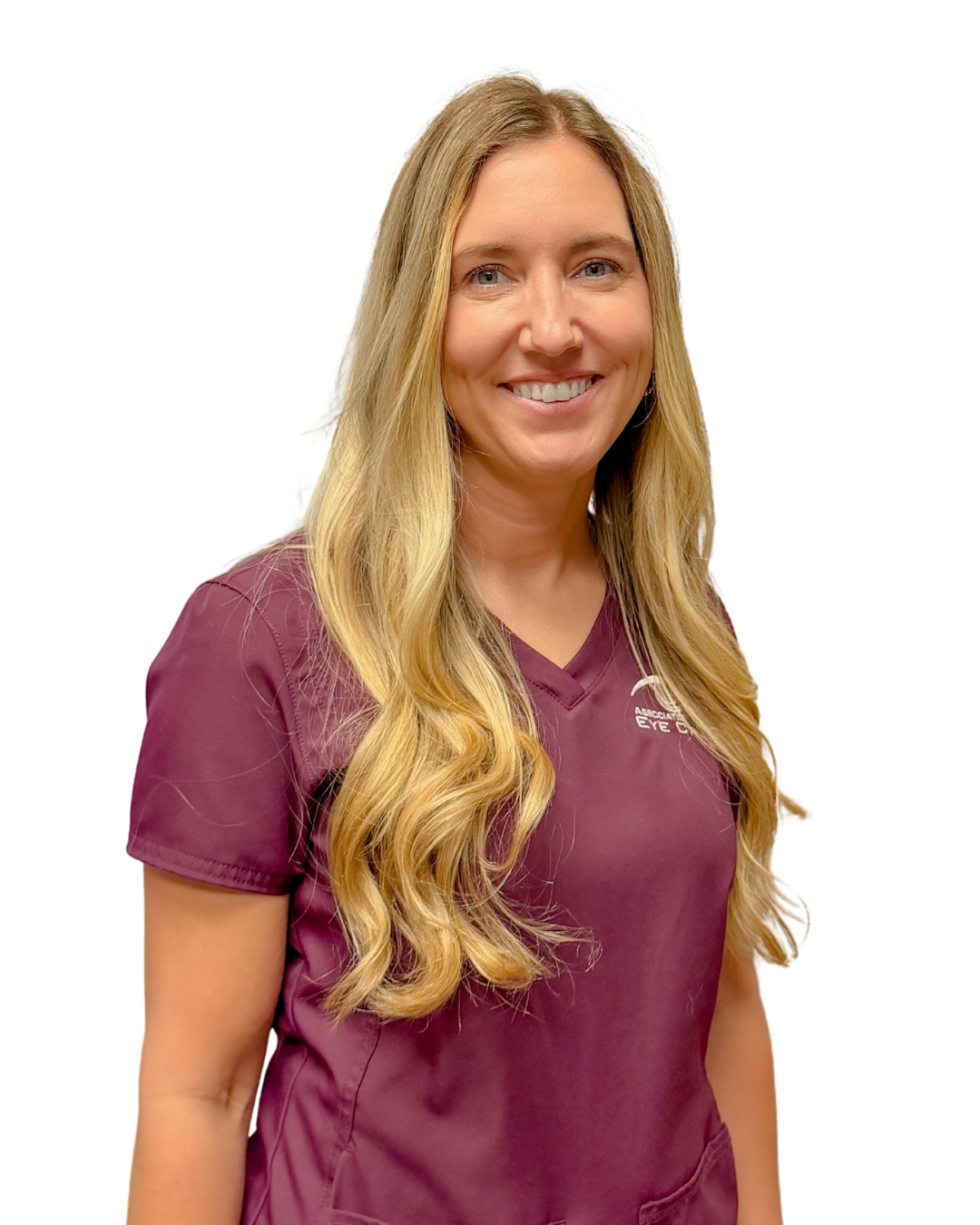 Smiling woman with long blonde hair wearing a blue scrub top against a white background.