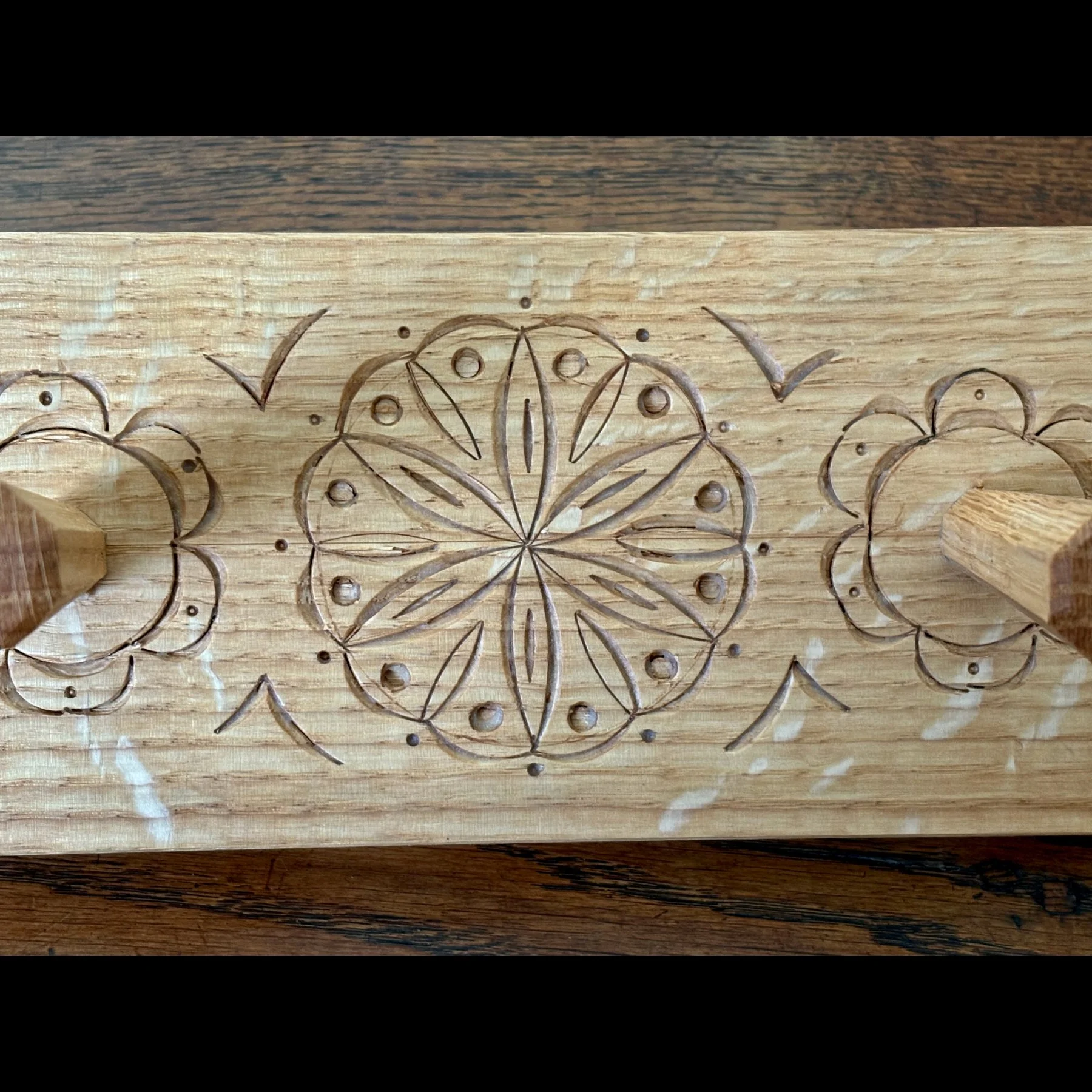 closeup of carving on peg rack