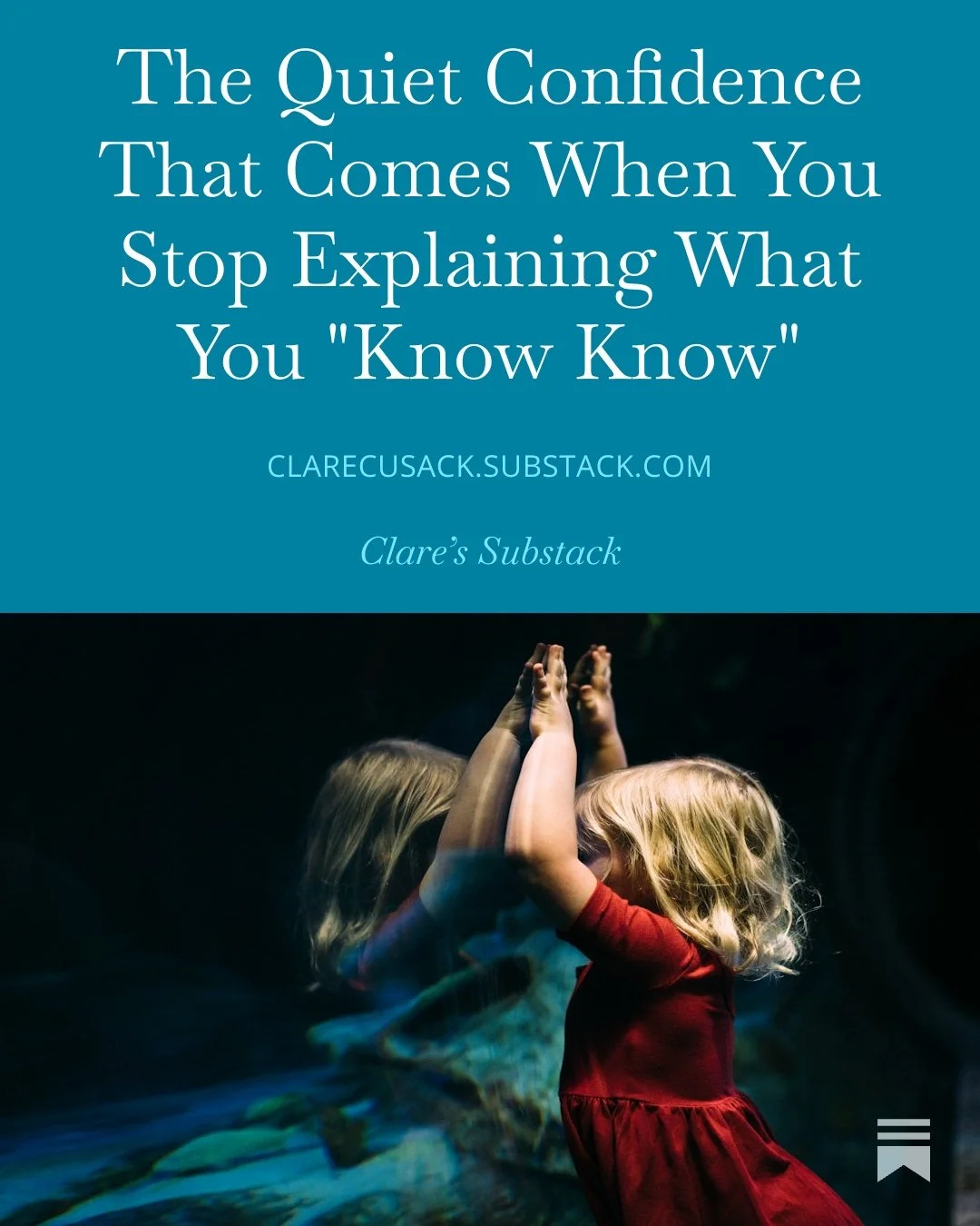 Two young children with blonde hair, one wearing a red dress, face each other with palms pressed together, creating a mirror image effect with a dark background.