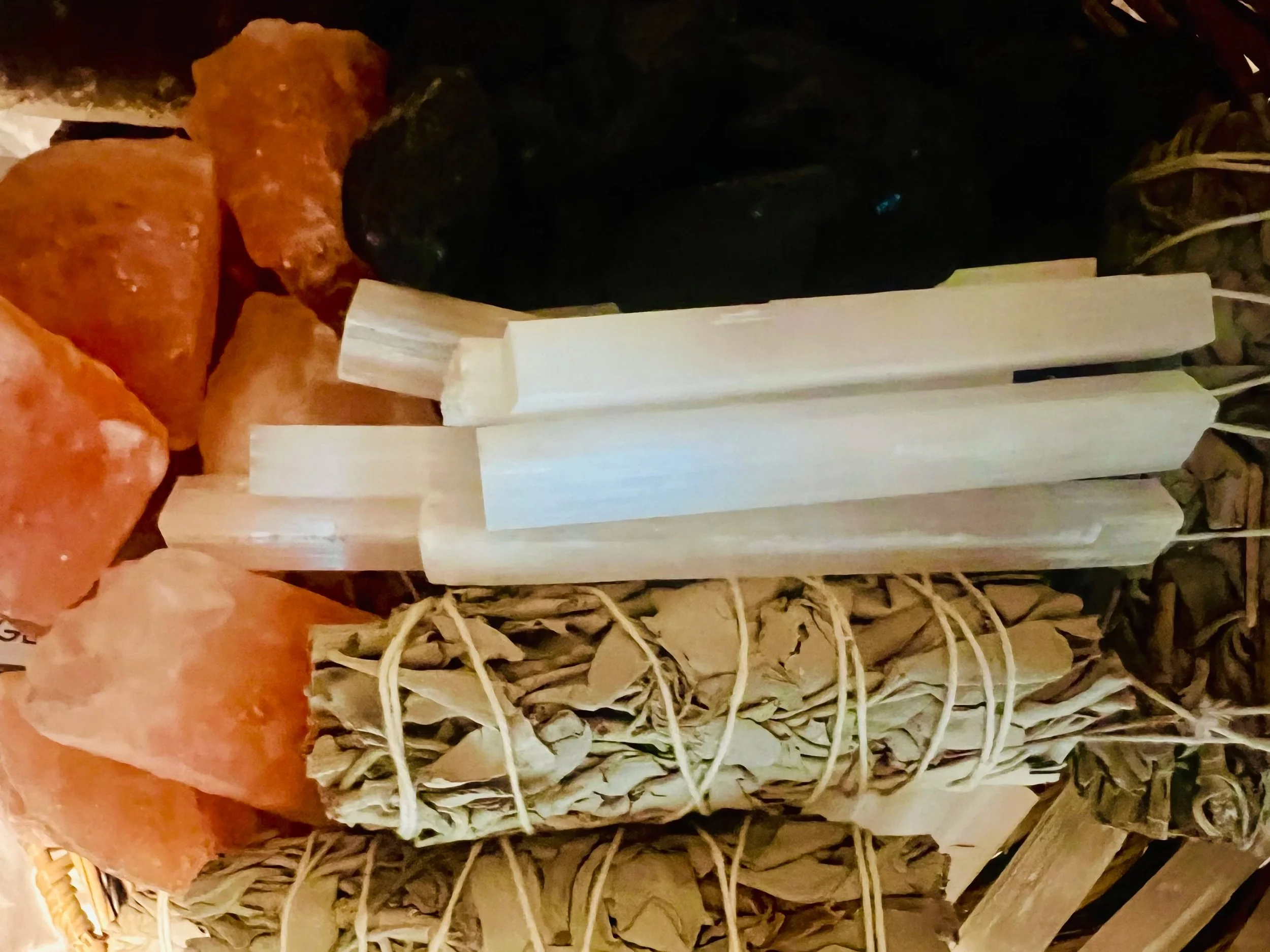 Close-up of several orange carrots and a bundle of dried herbs wrapped in string.