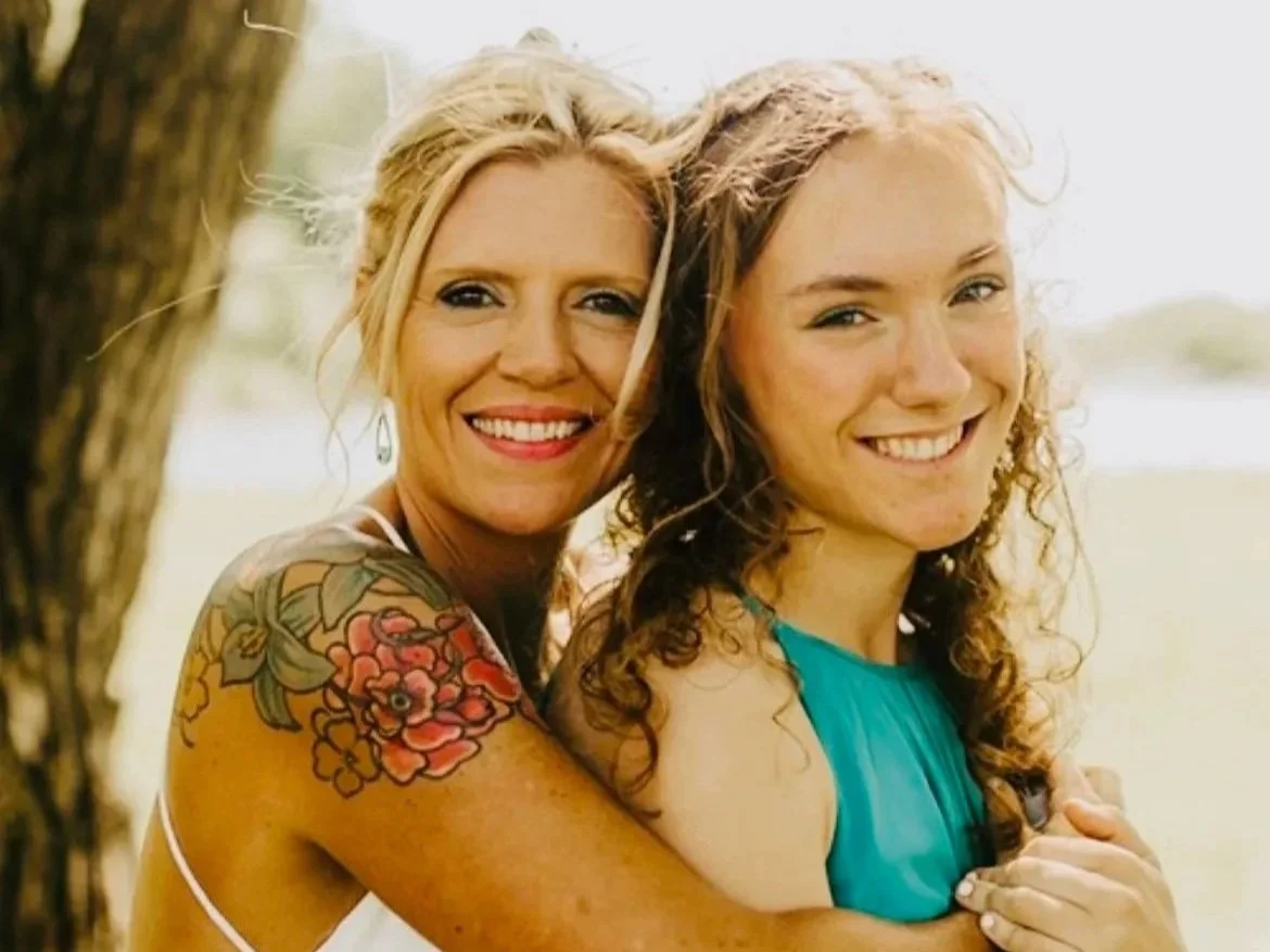 A mother and daughter embraced in a loving photo