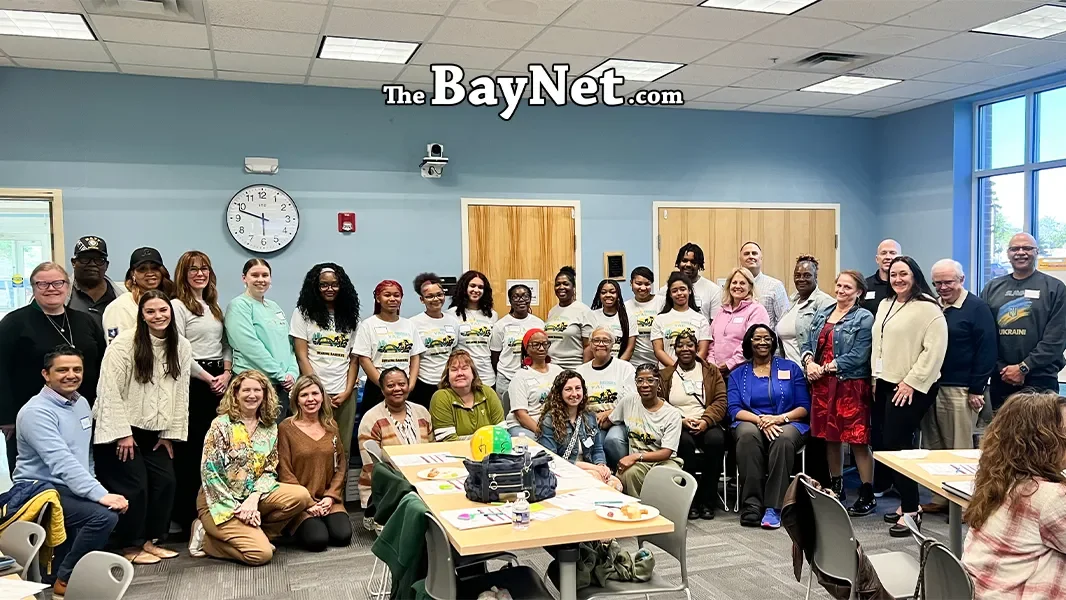 A diverse group of approximately 30 community members and partners pose together at the Lexington Park Neighborhood Strategy Meeting, April 2026.