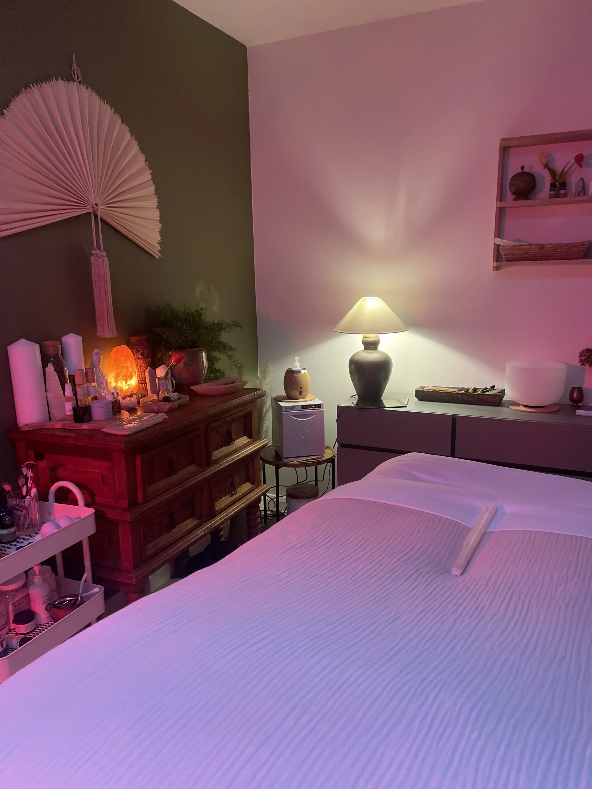 Person receiving a facial massage in a spa setting.
