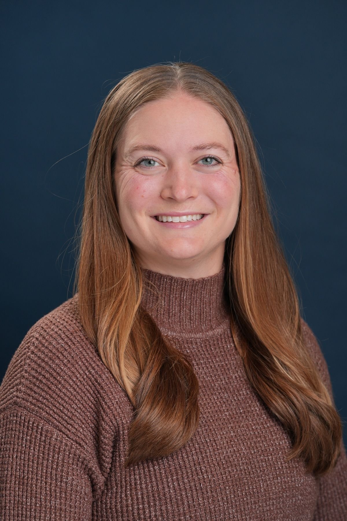 Headshot of Gaylen Fronk wearing a brown sweater