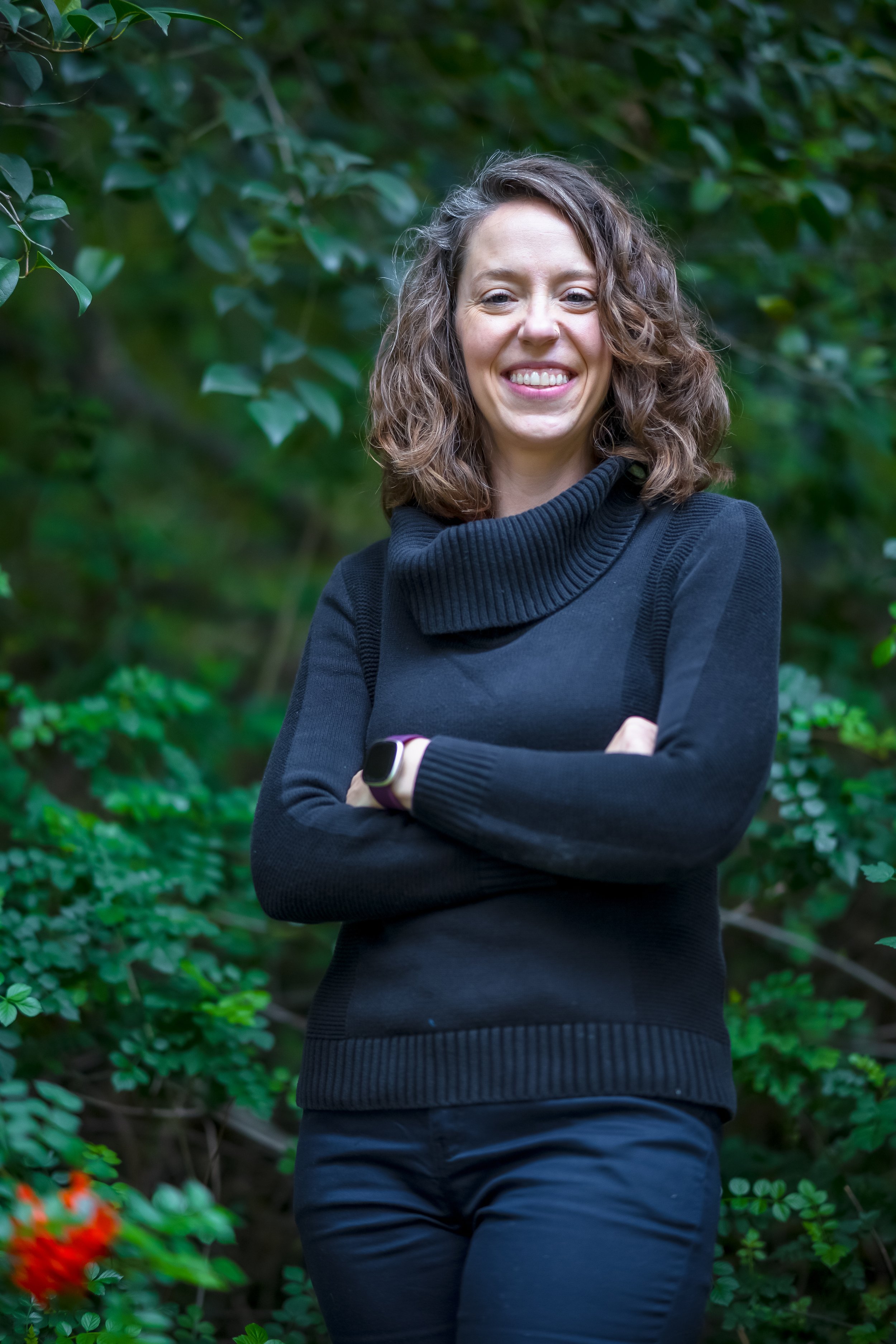Headshot of Rebecca Williams with a leafy background