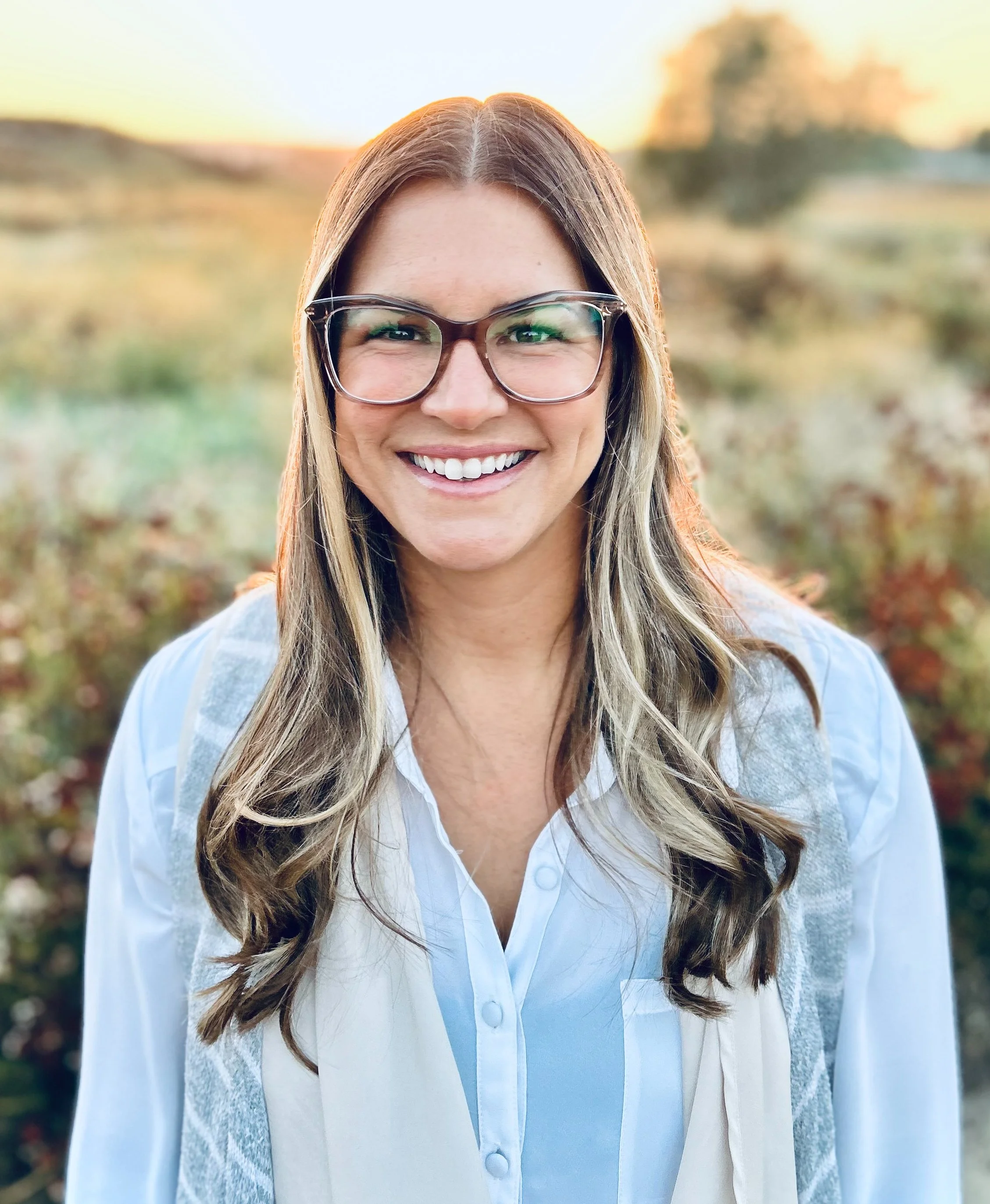 Headshot of Jacquelynn Fliestra with nature background
