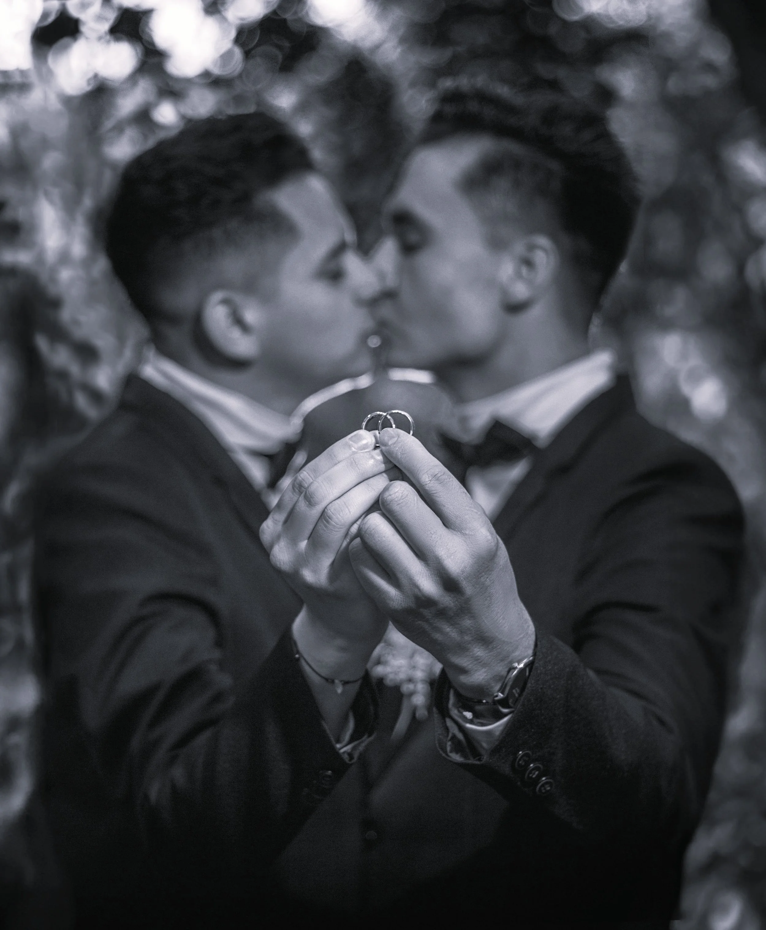 black and white photo of a couples kissinf and holding ringsPremarital Counseling California