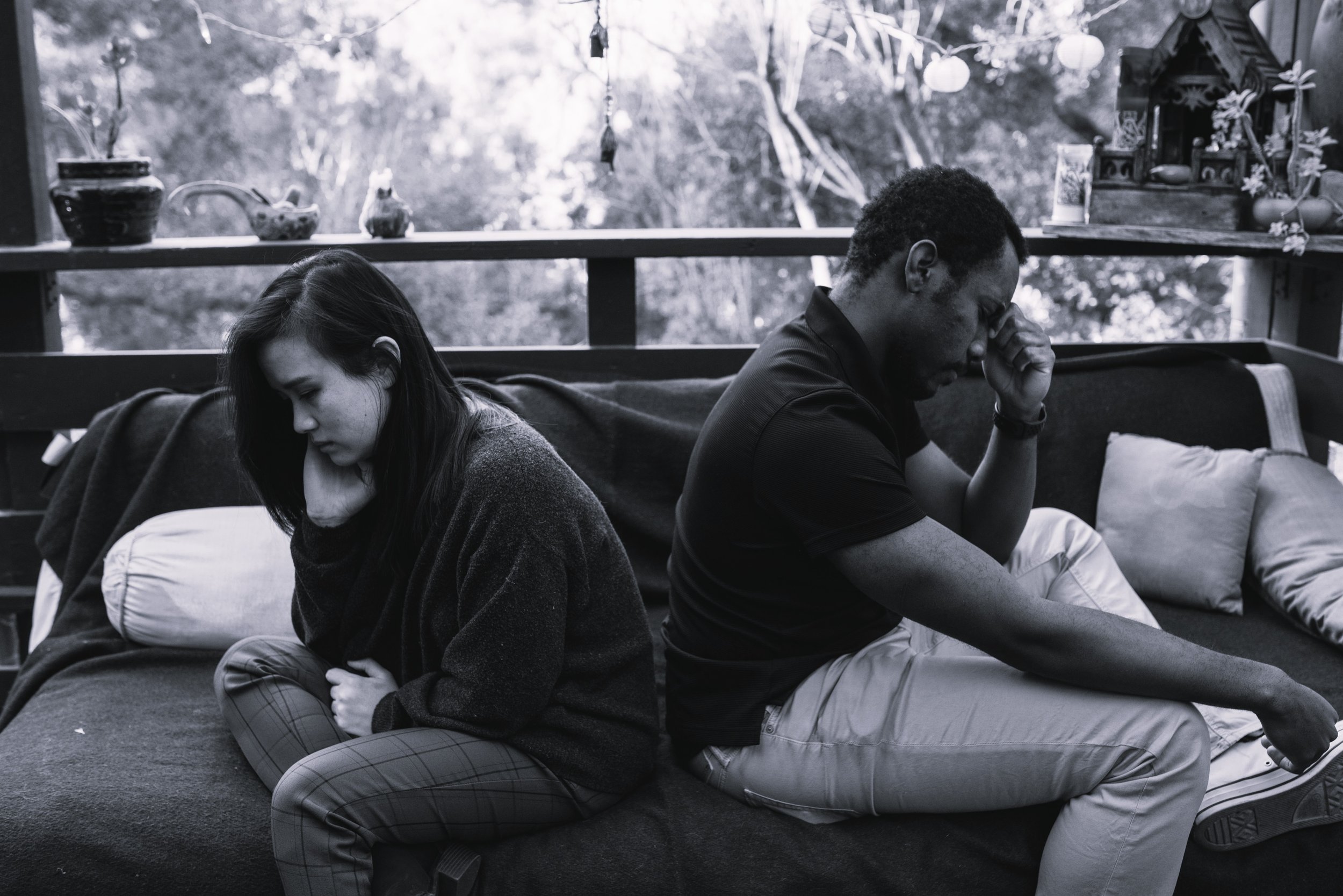 Couple sitting on couch having a disagreement