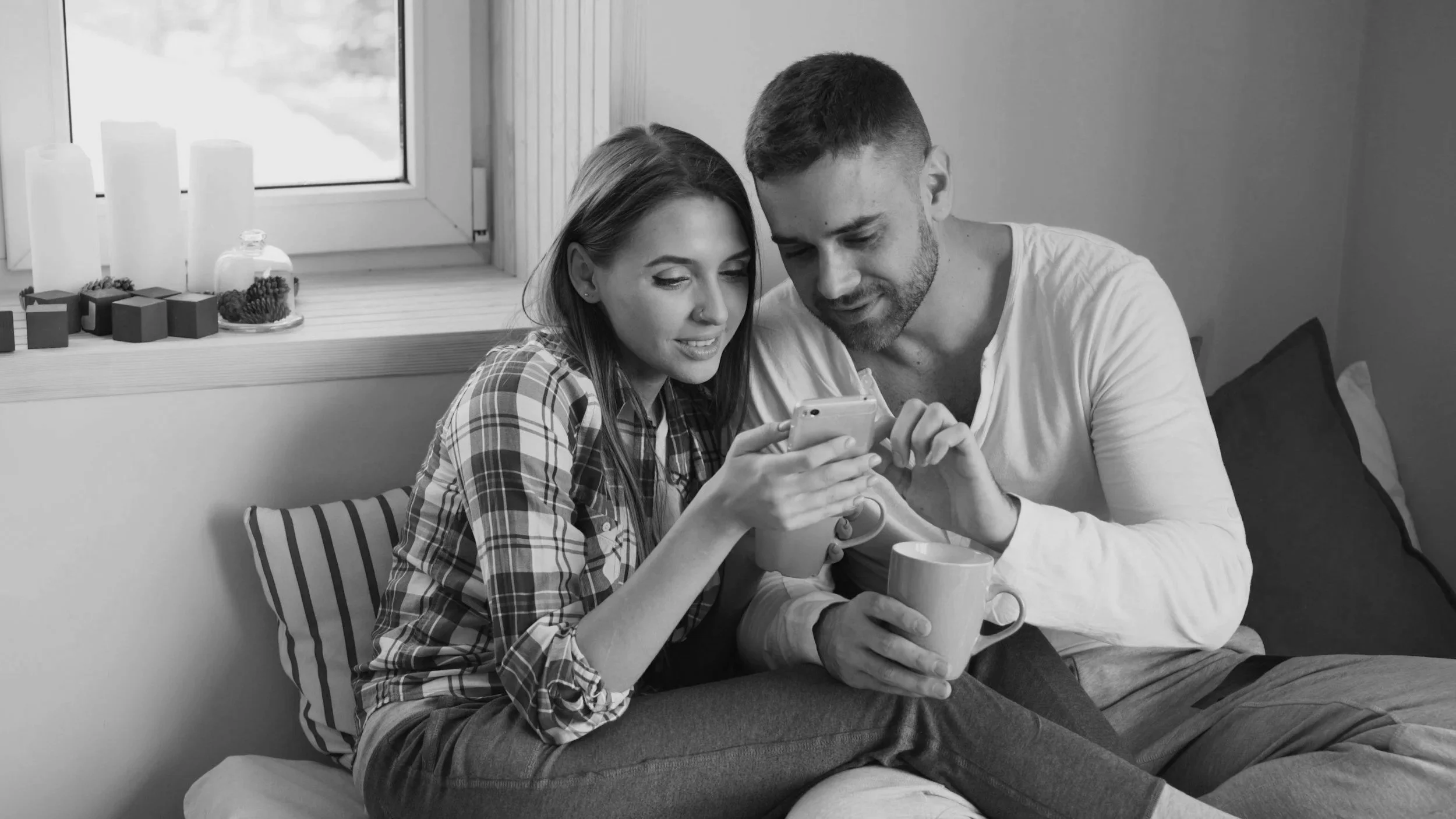 Black and white photo of couple looking at the phone Couples counseling in California
