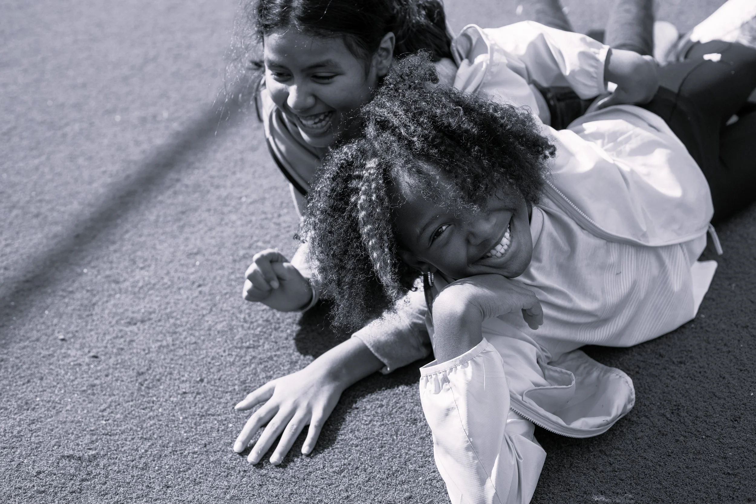 black and white photo of children laughing mixed faith family counseling