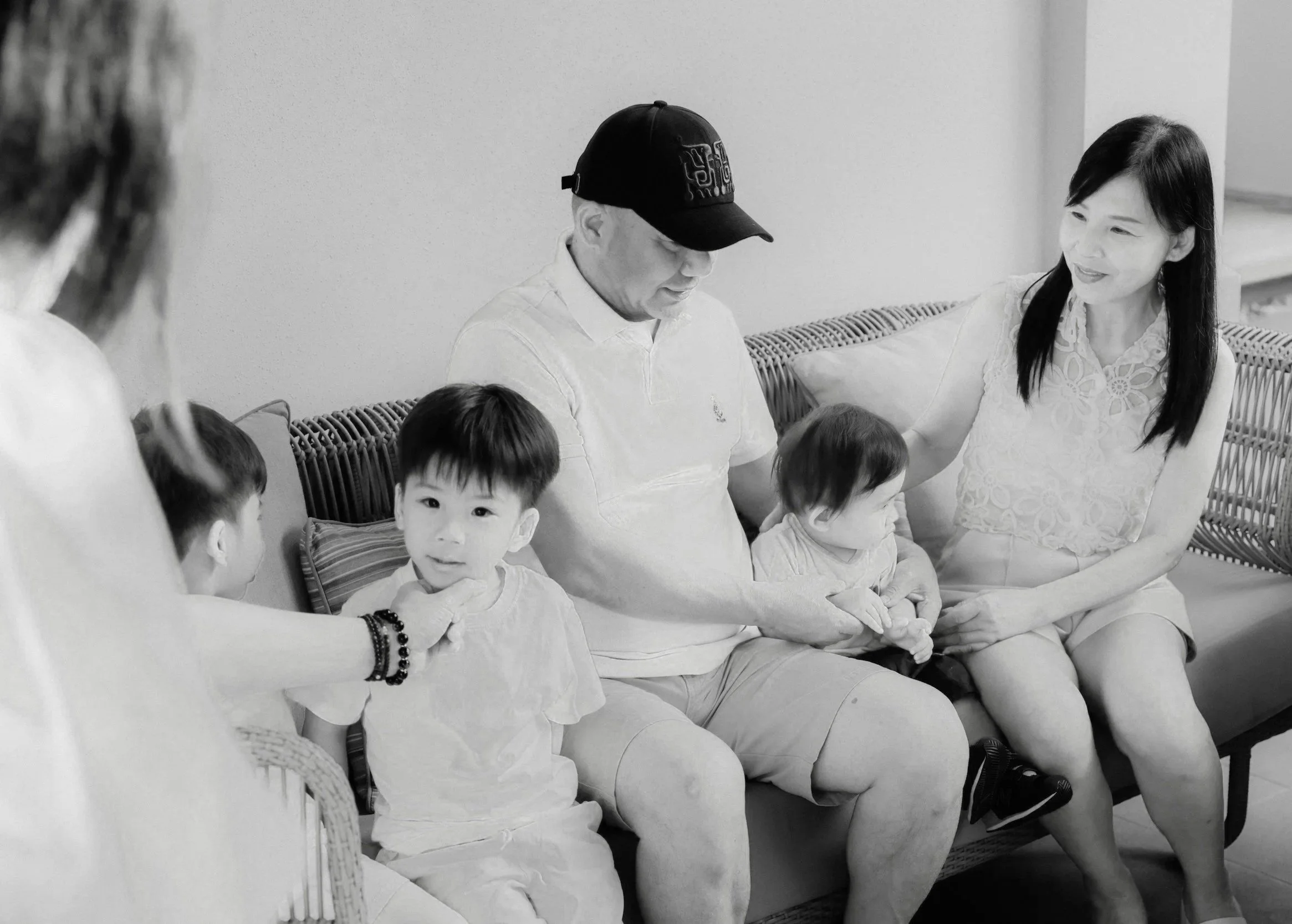 Adults and children of mixed ages and races in a black and white photo. They are a blended family looking for family counseling in california at Inland Empire Couples Counseling