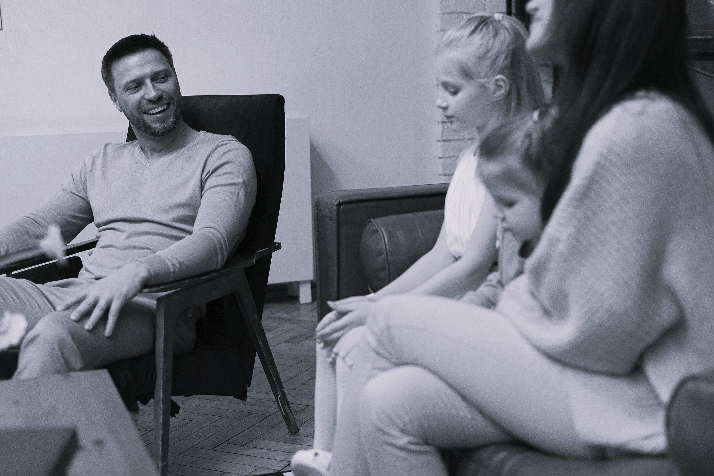 Black and white photo of family with an interfaith background having therapy