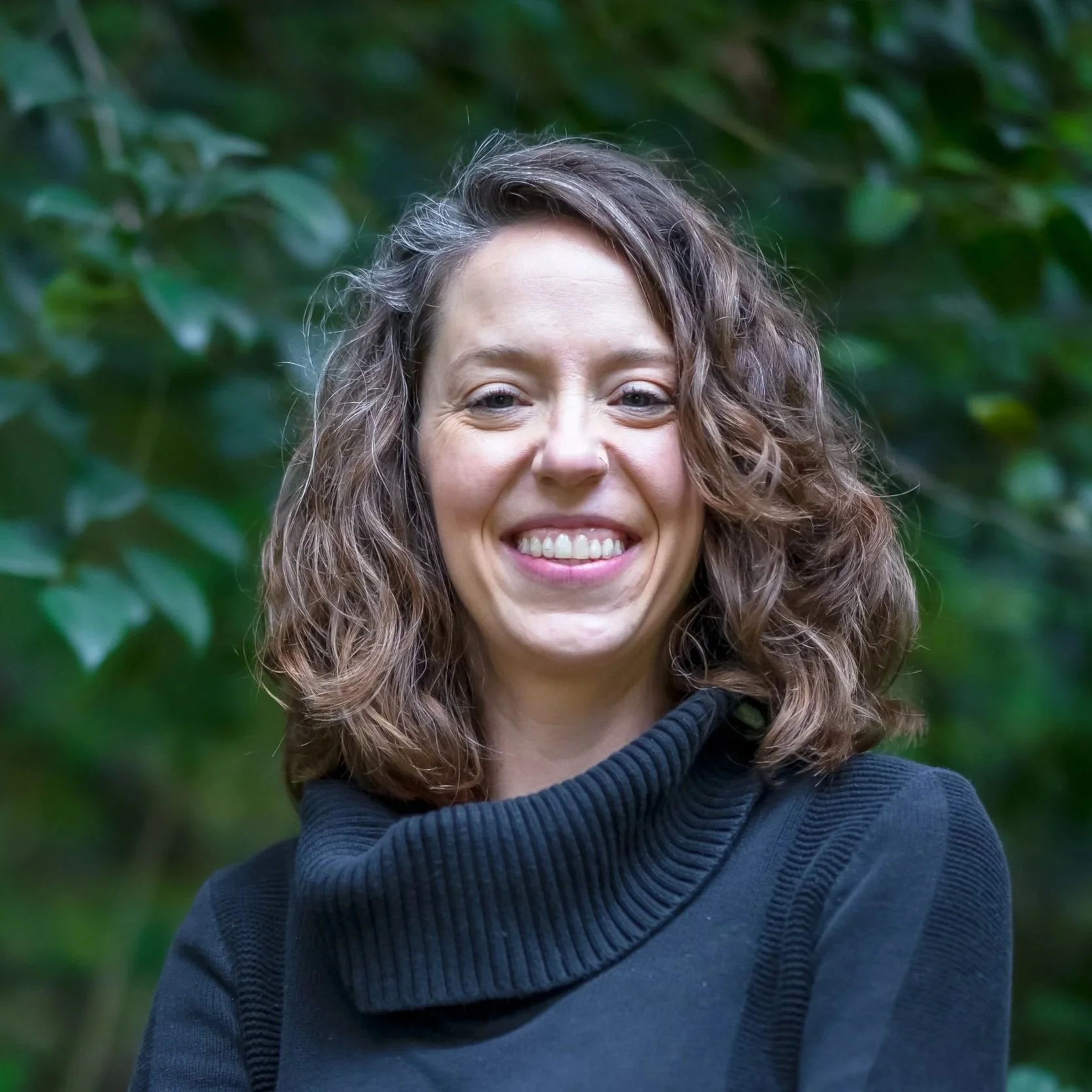 headshot of Rebecca Williams with leafy background