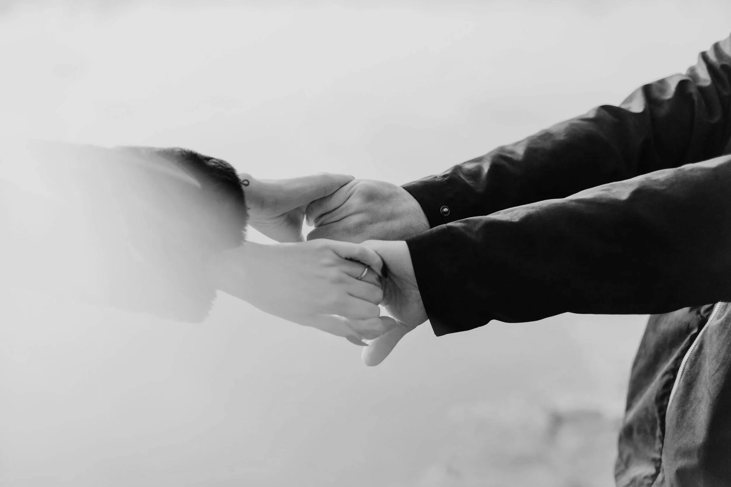 Black and white photo of hands holding