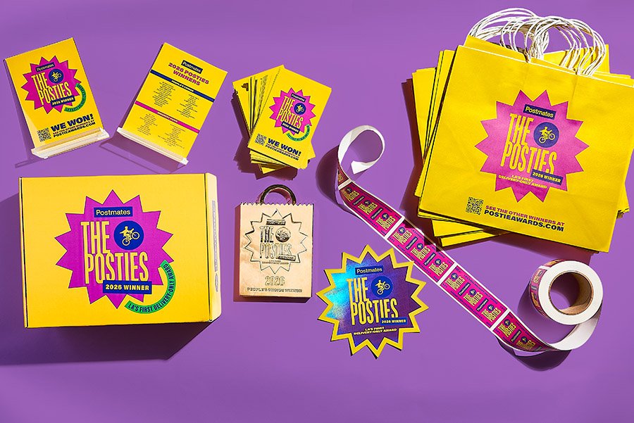 Printed Postmates award kit components including winner cards, labels, stickers, and branded packaging