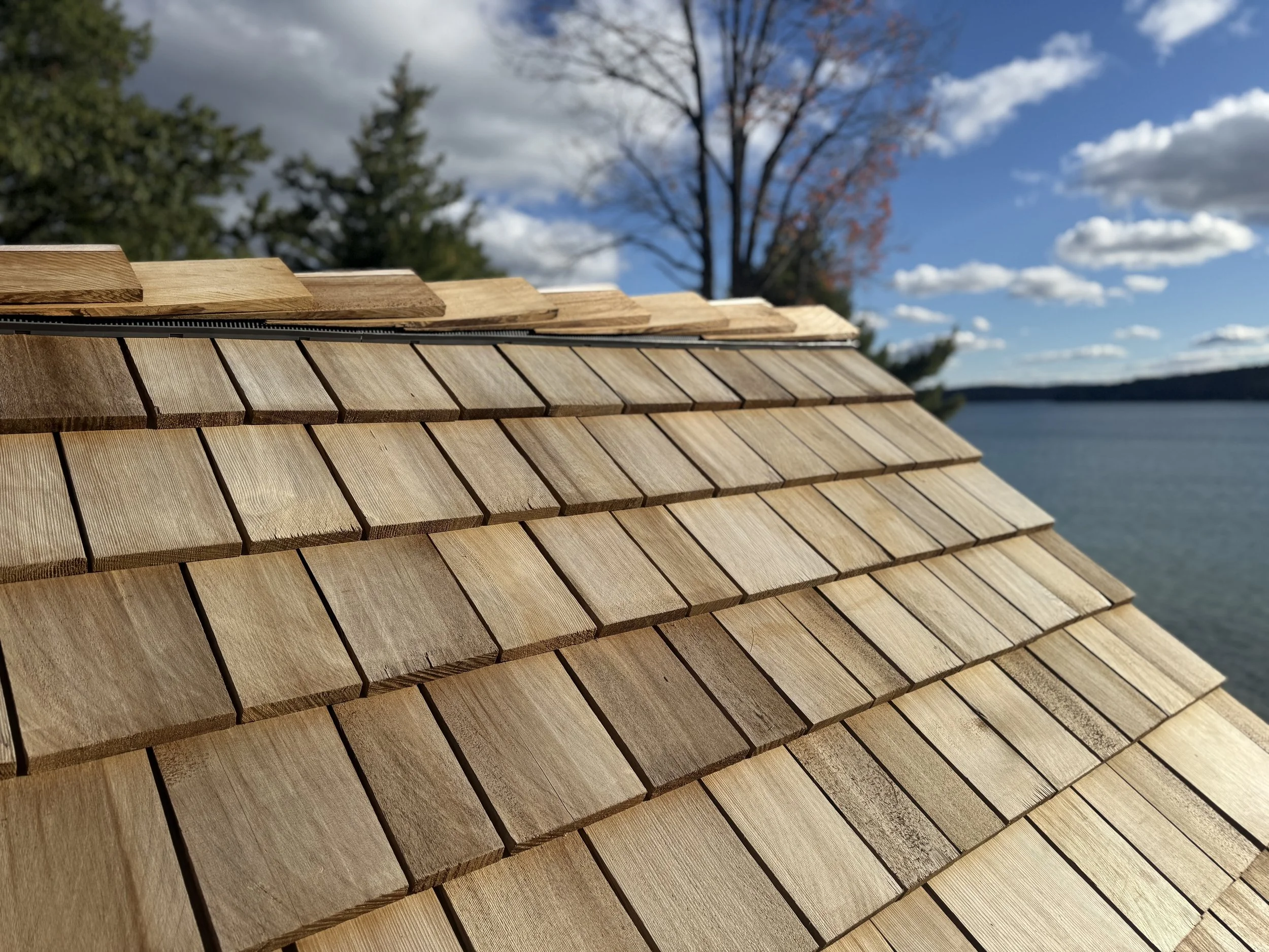 Tapersawn cedar shake shingle roof overlooking Walloon Lake at sunset, installed by Petoskey Roofing