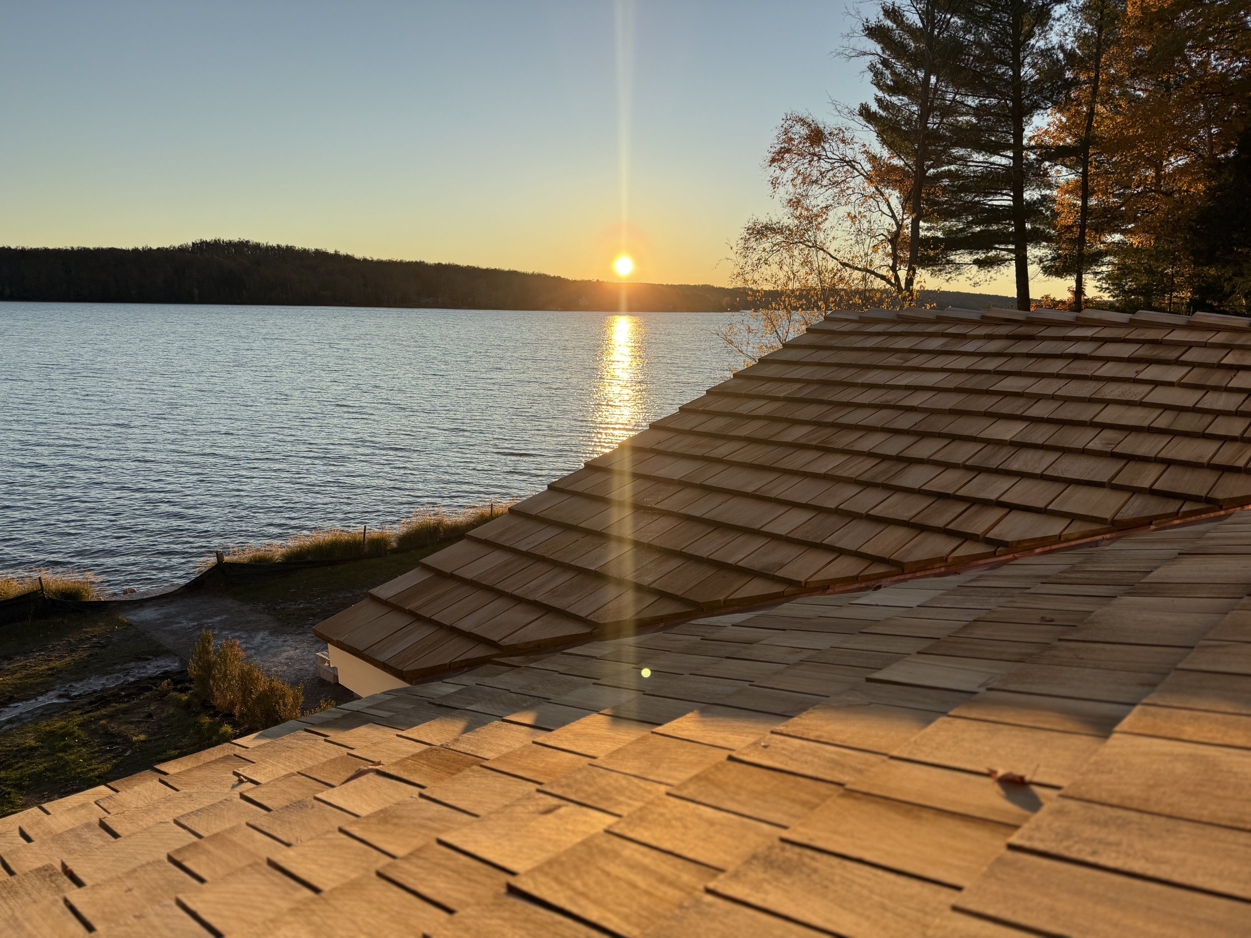 Tapersawn cedar shake shingle roof overlooking Walloon Lake at sunset, installed by Petoskey Roofing