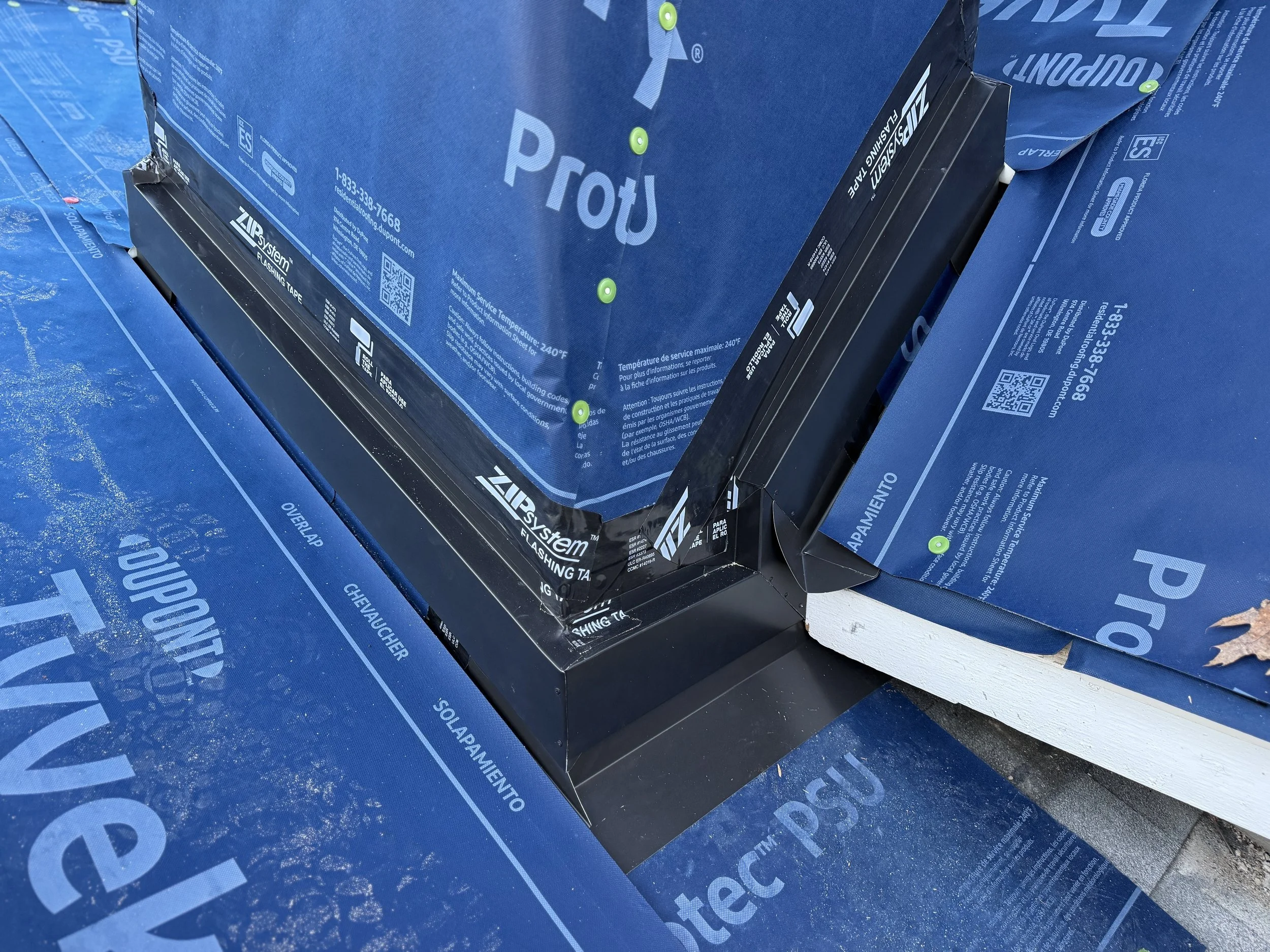 New 24-gauge steel chimney curb and counter flashings with DuPont underlayment in Harbor Springs, Michigan